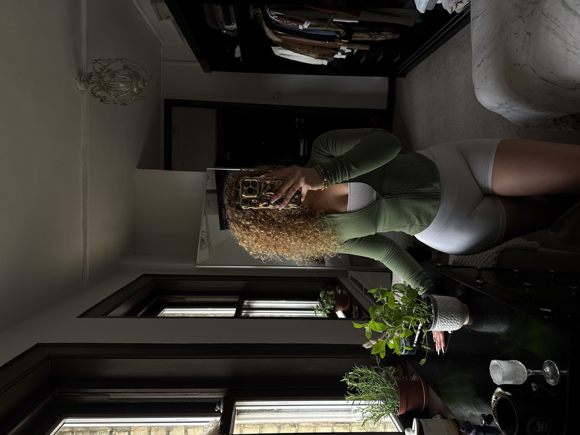 Woman documents plant care and green smoothie in London bedroom