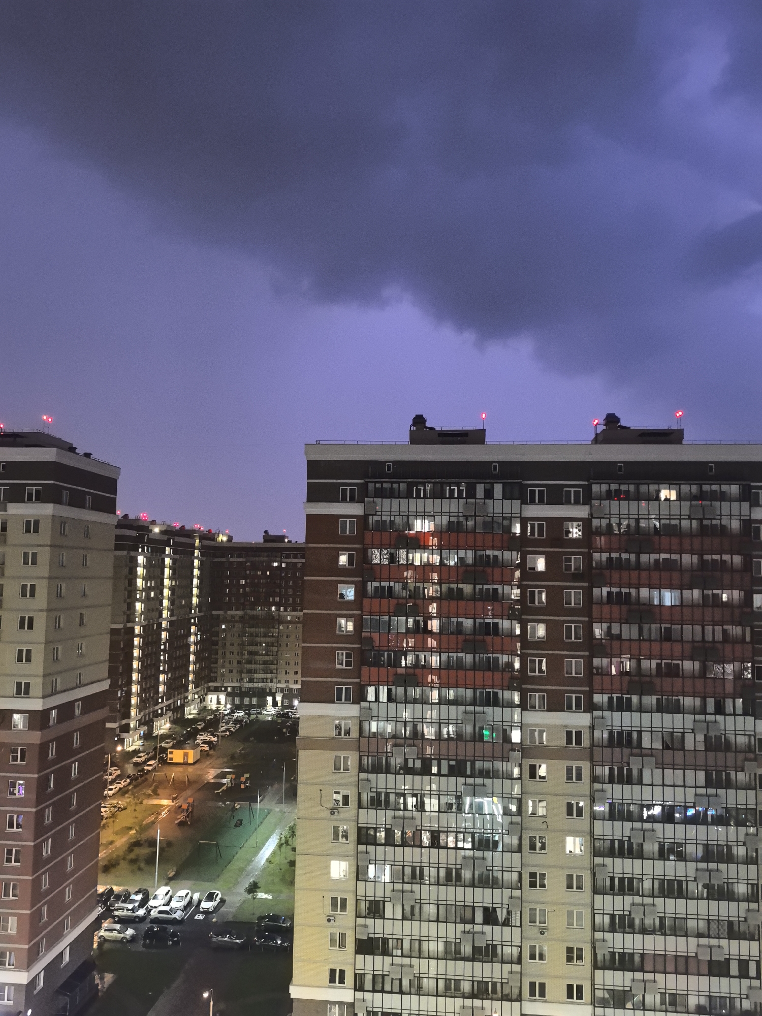 Urban apartment towers at twilight, lights coming on