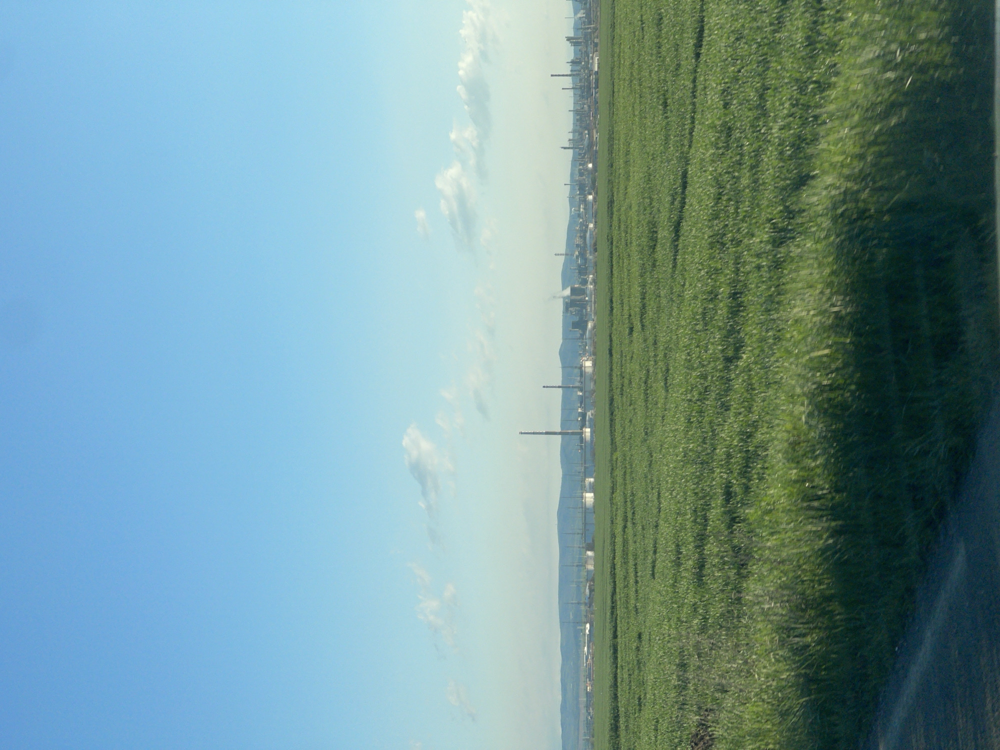 Morning view of industrial skyline from agricultural fields near Bratovo