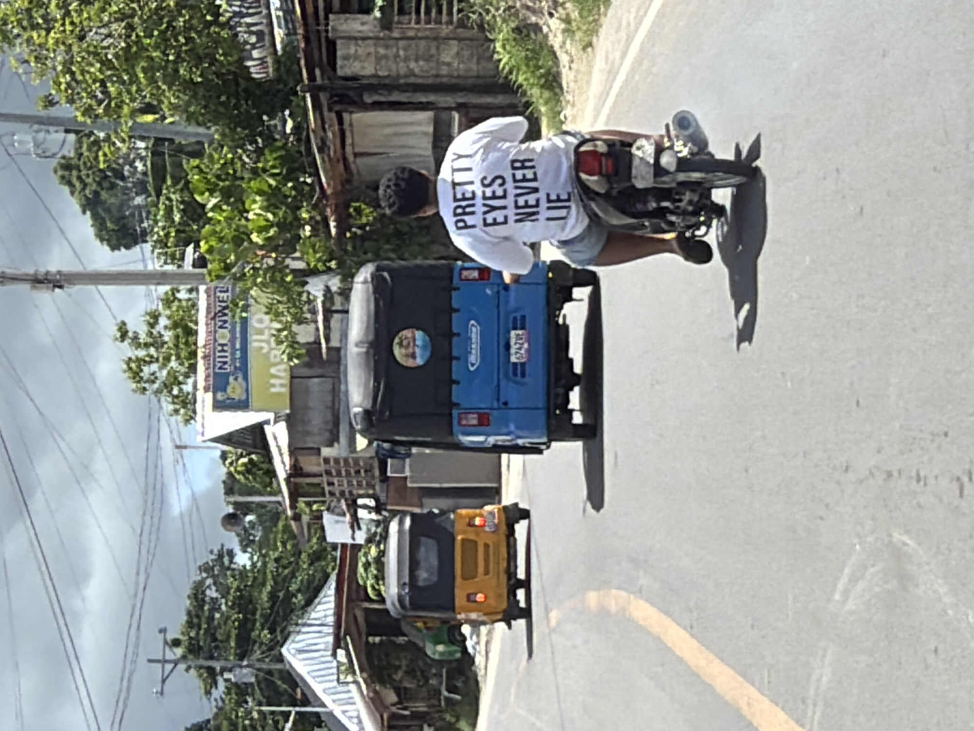 Early morning tricycle ride captured on General Luna coastal road