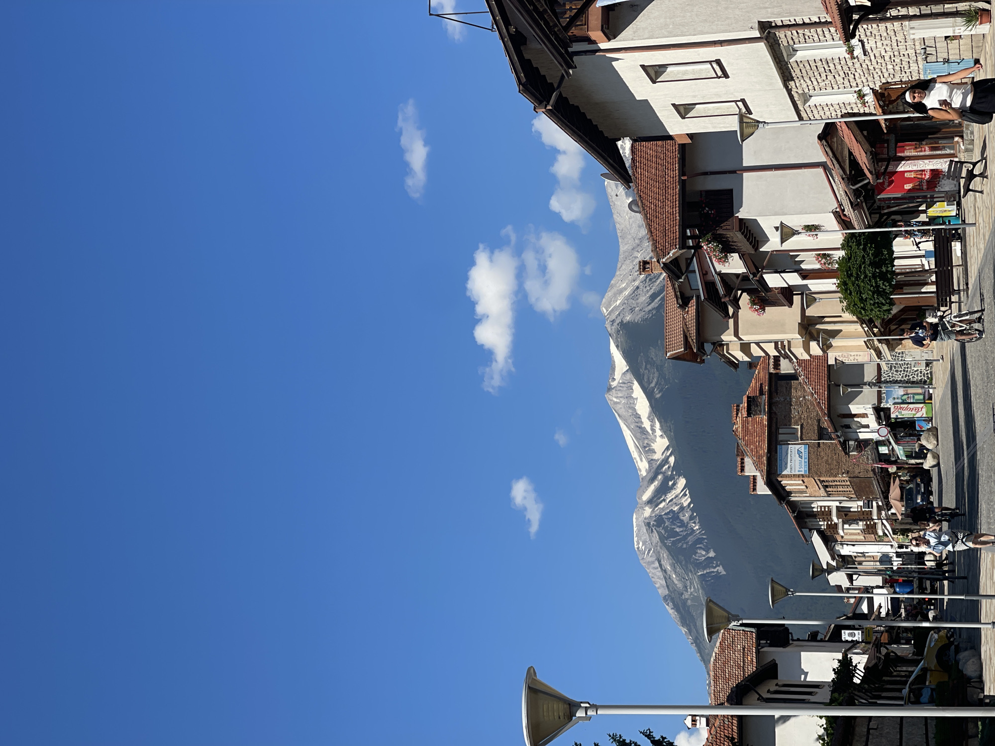 Mountain range frames the end of a quiet narrow street
