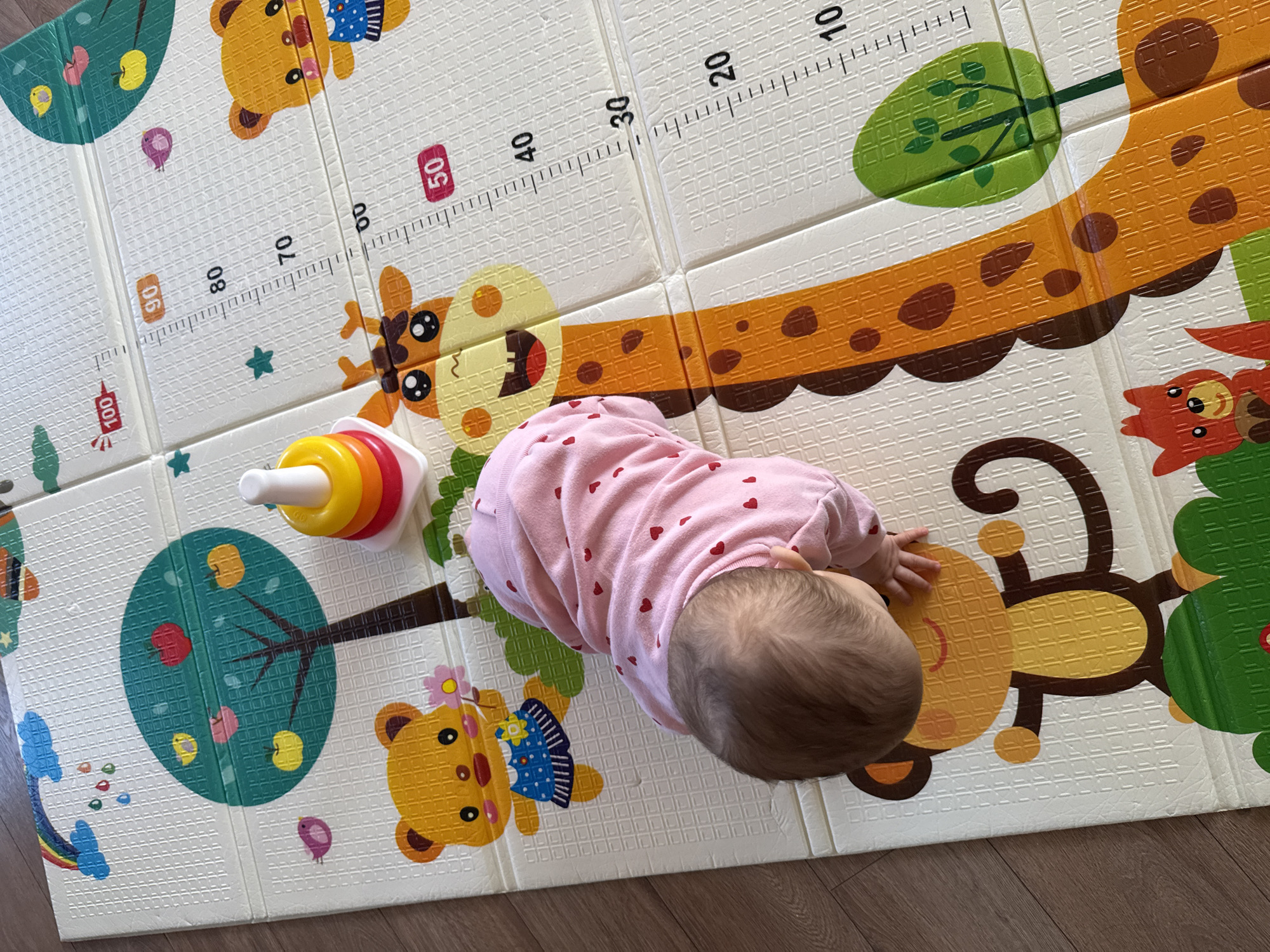 Baby plays on colorful foam mat in Sofia