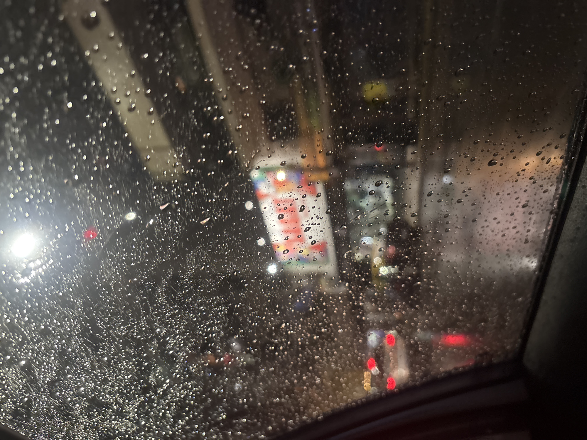Rainy night drive captured through windshield in Buenos Aires