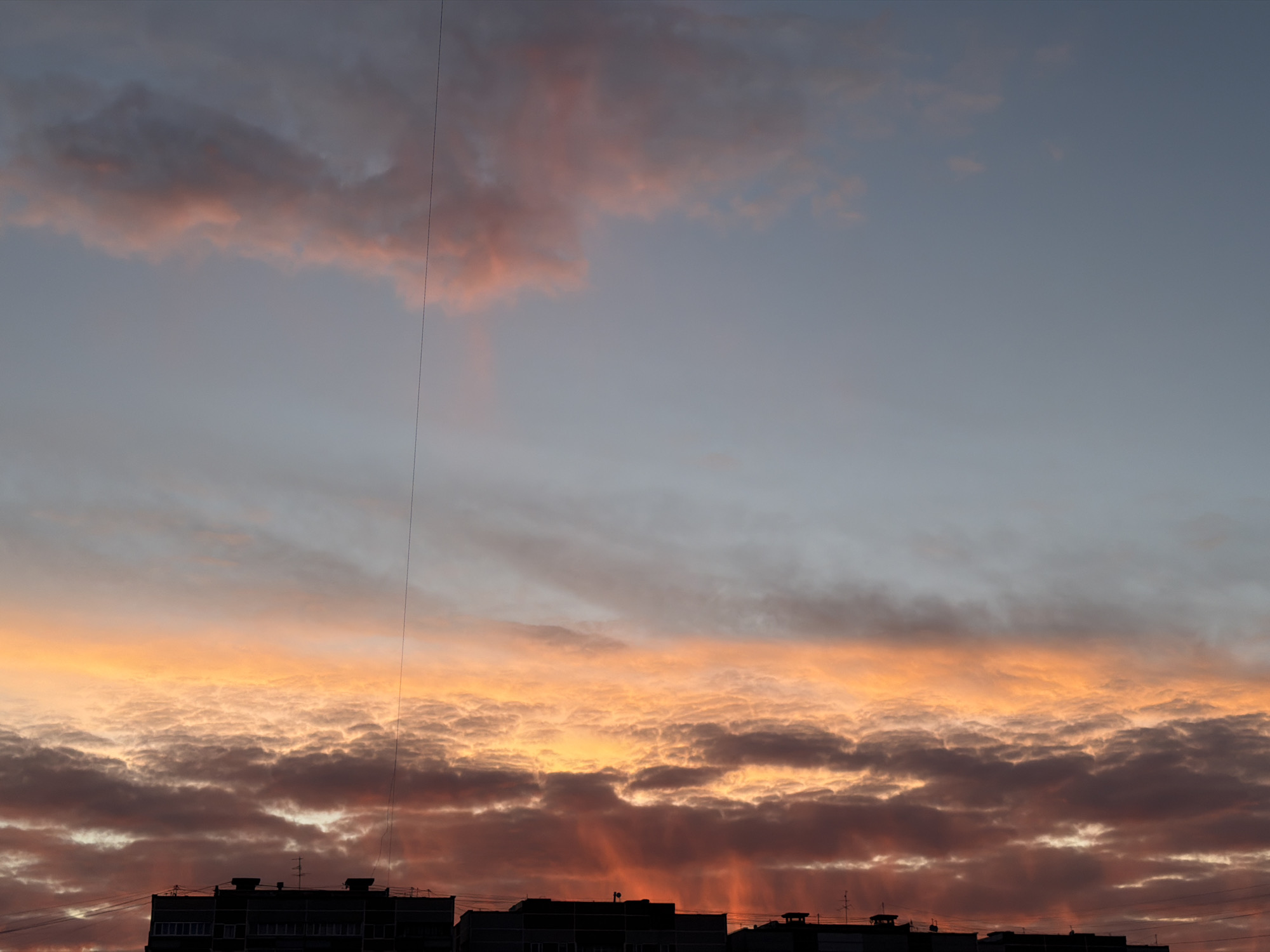Dramatic sunset illuminates Riga skyline with vivid colors