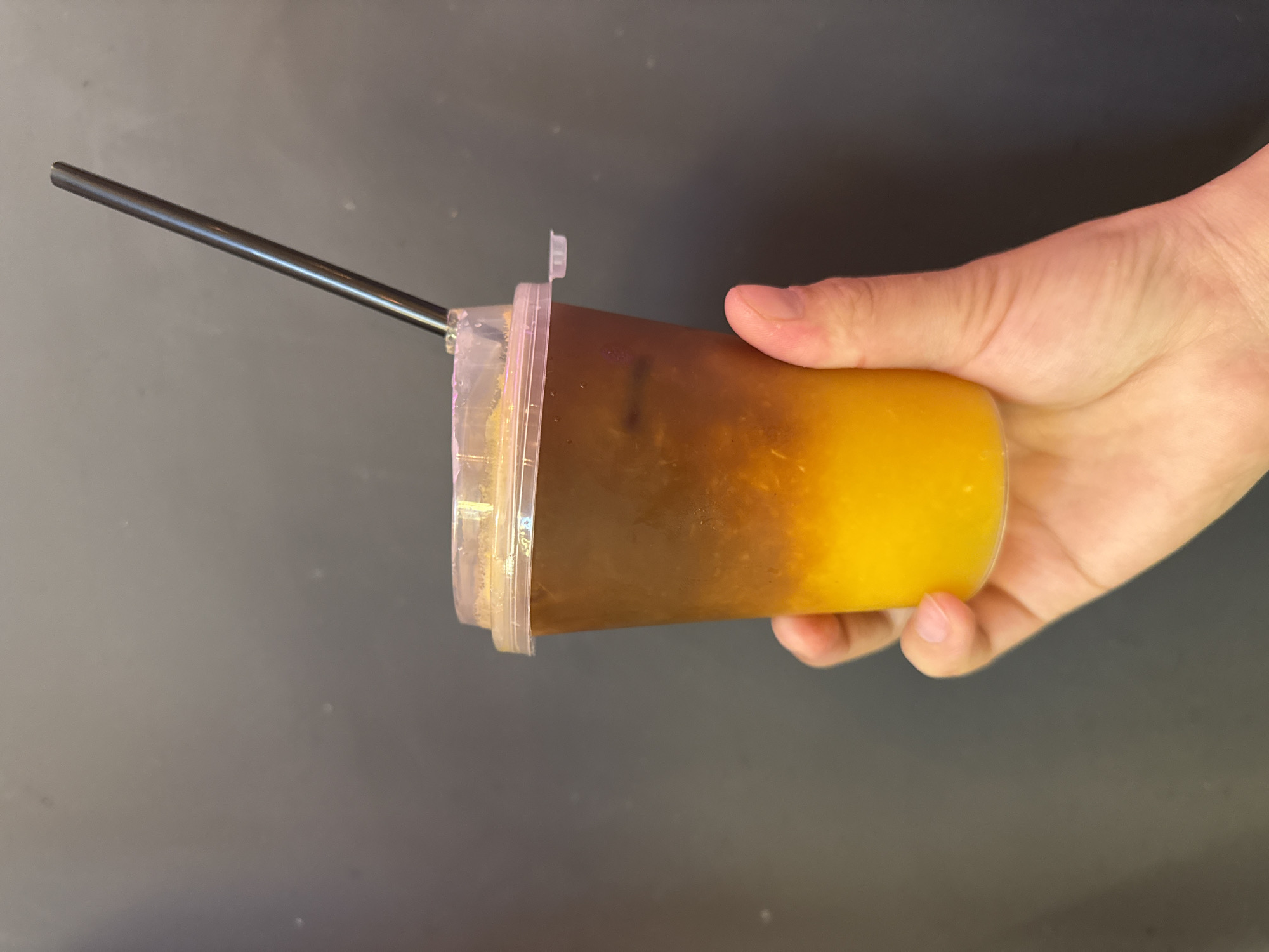 Customer enjoys layered drink at Dolgoprudny cafe