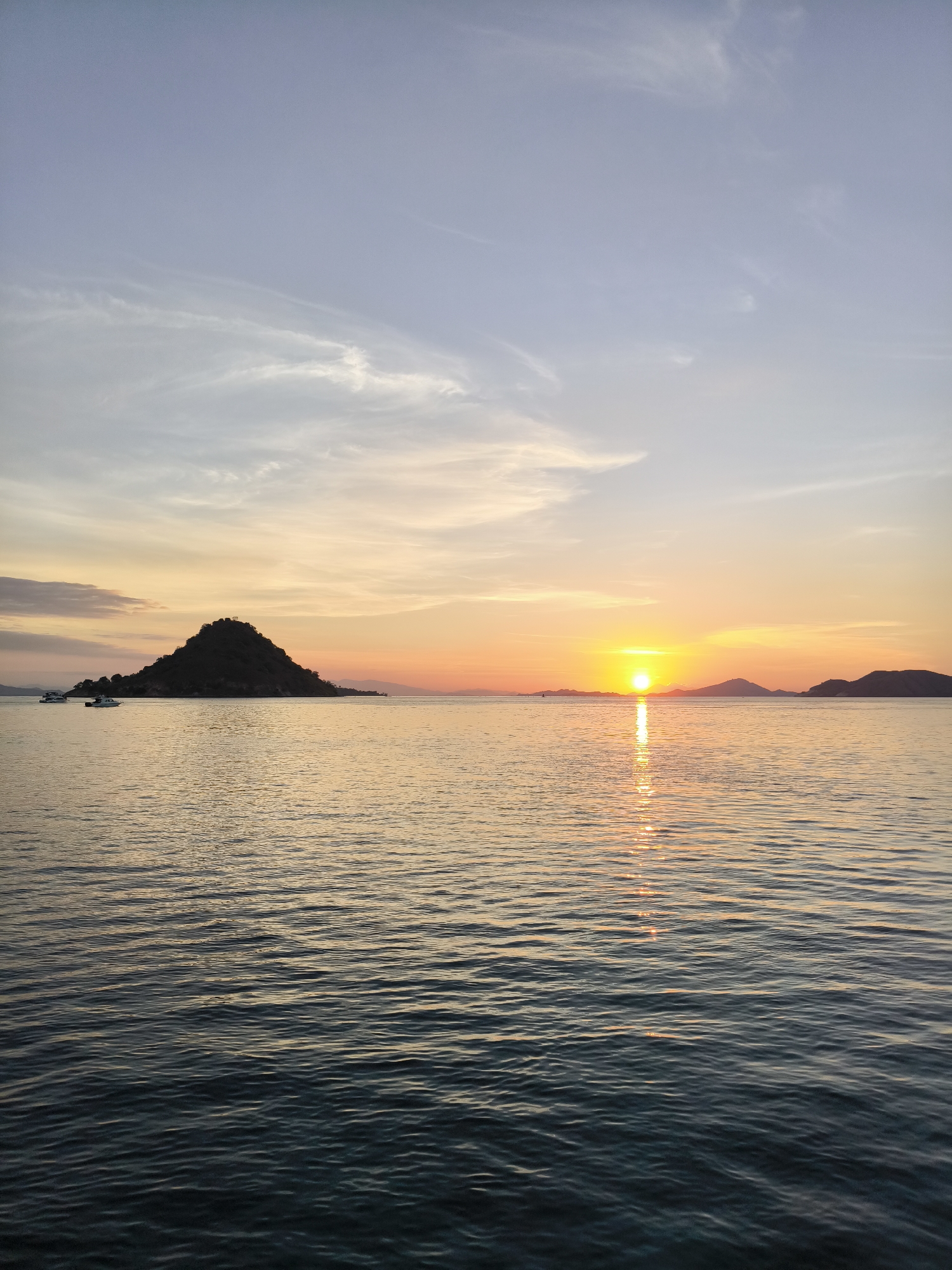Reef sharks and a golden sunset off the Indonesian coast