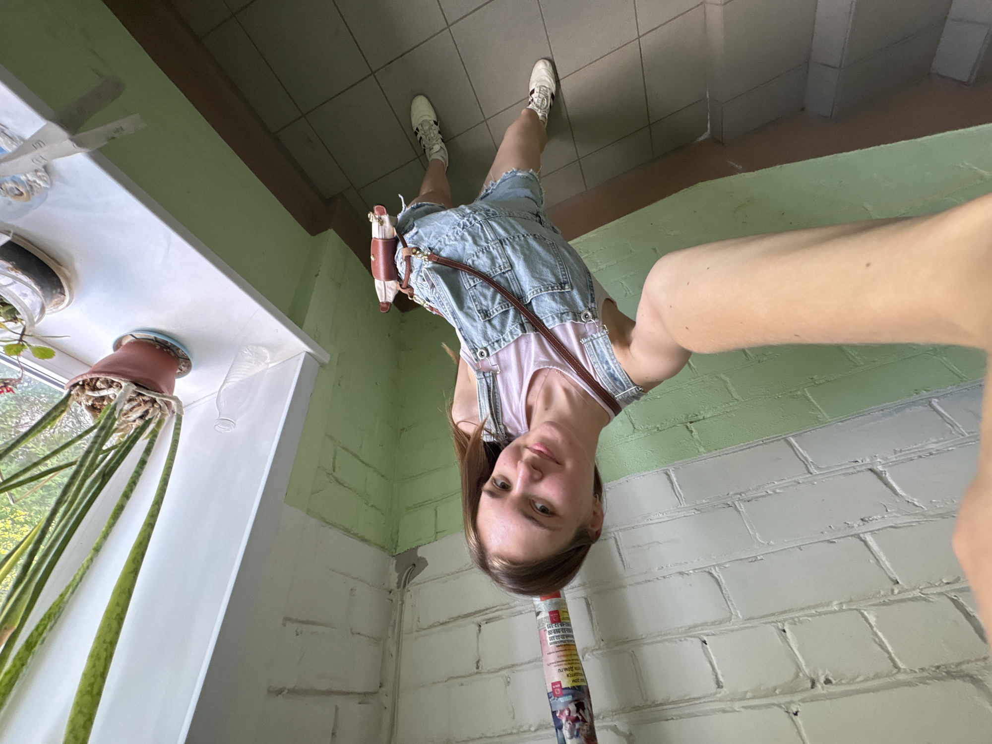 Woman takes selfie in residential building hallway in Perm