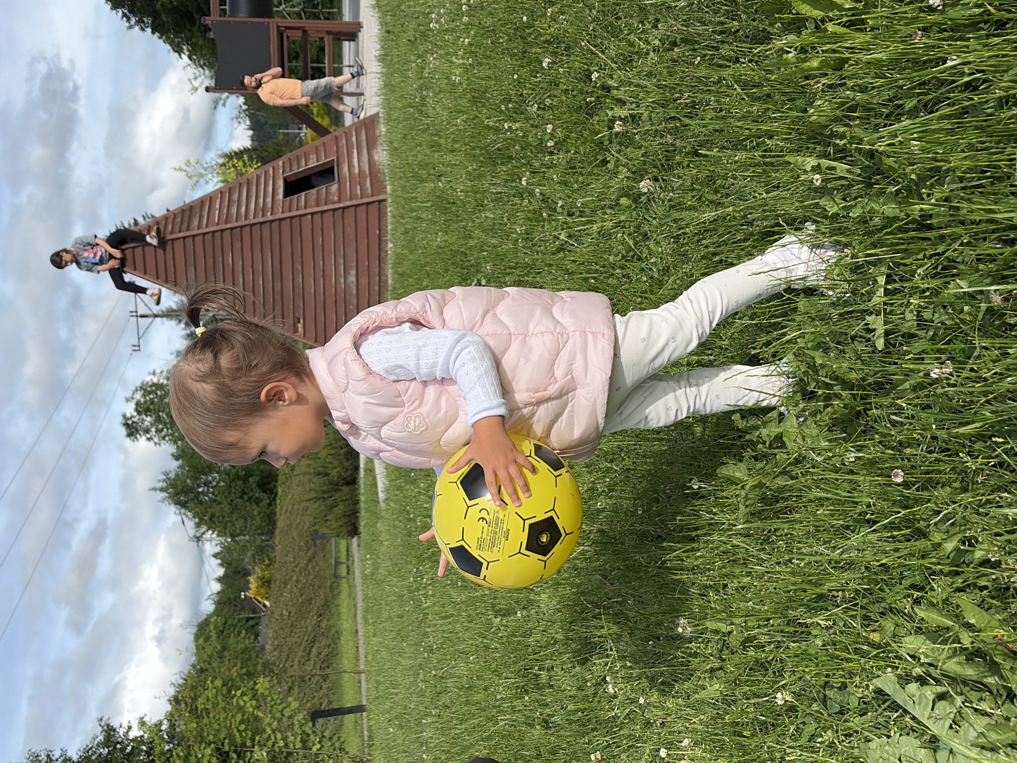 Toddler plays with soccer ball in Wisła park