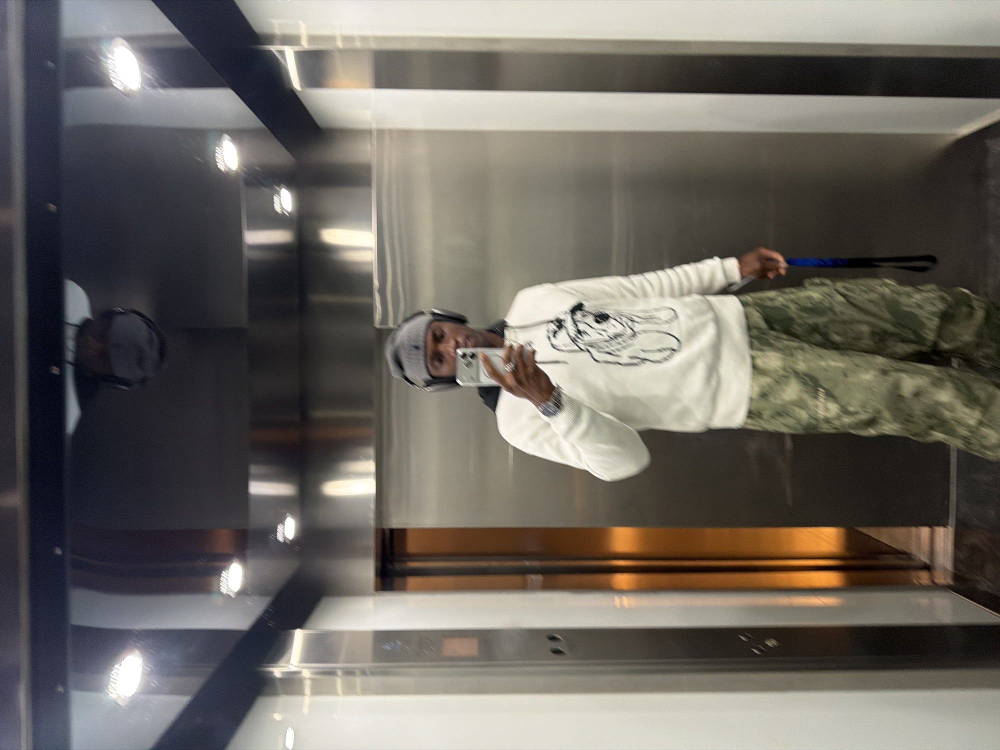 Person takes mirror selfie in London elevator