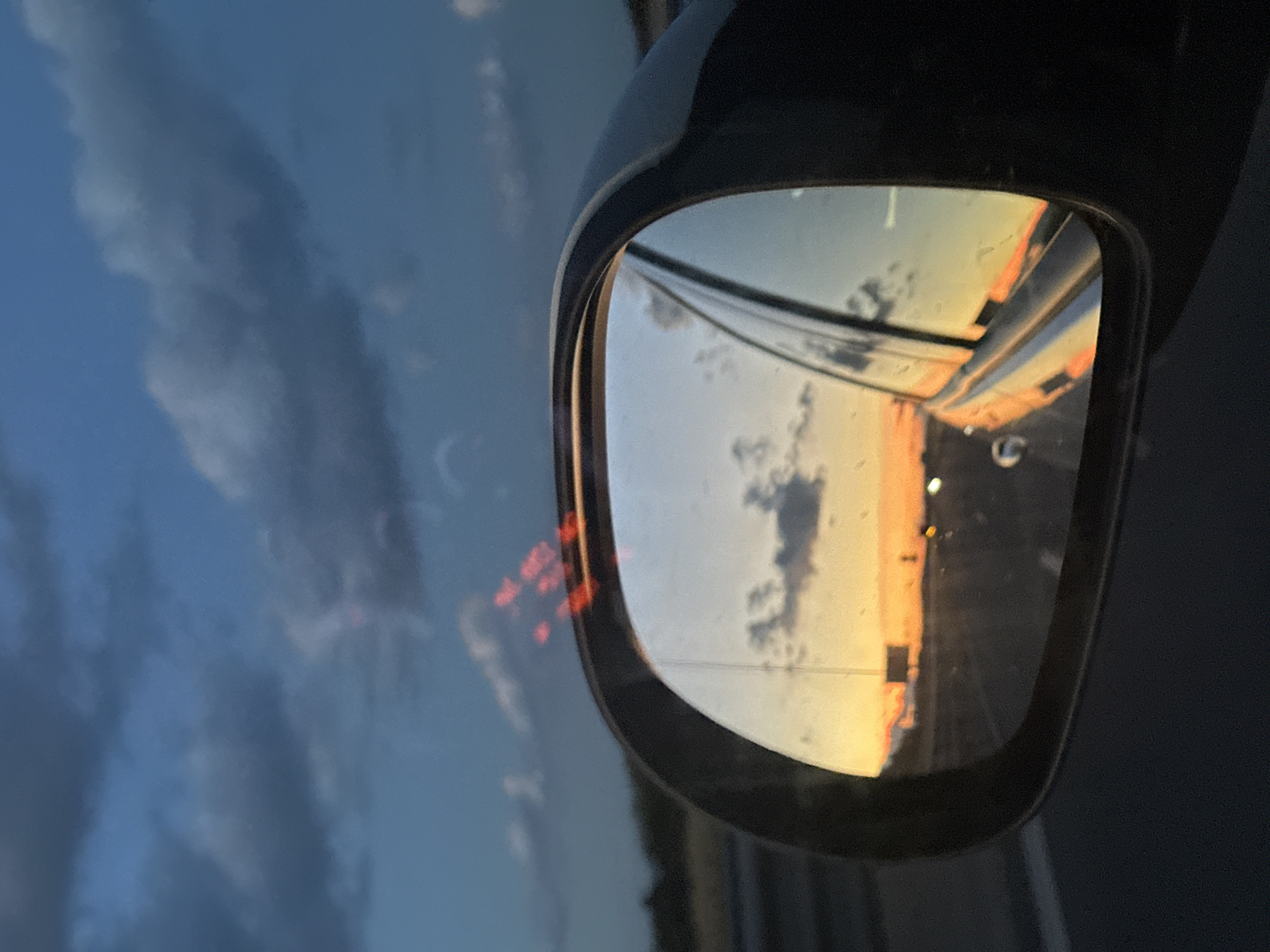Highway sunset reflected in rearview mirror near Belozem