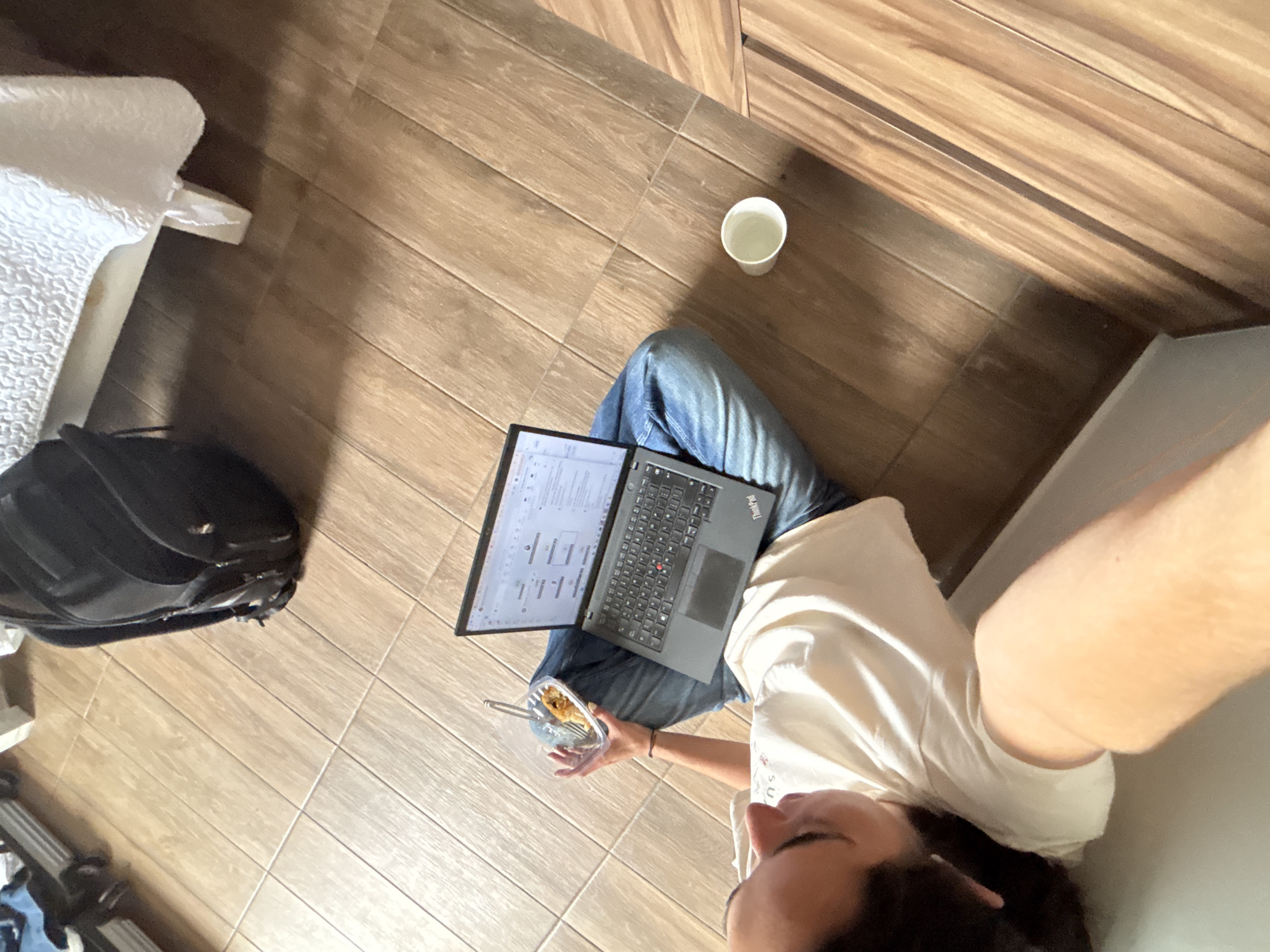 Person works on laptop from floor in Tlaxcalancingo