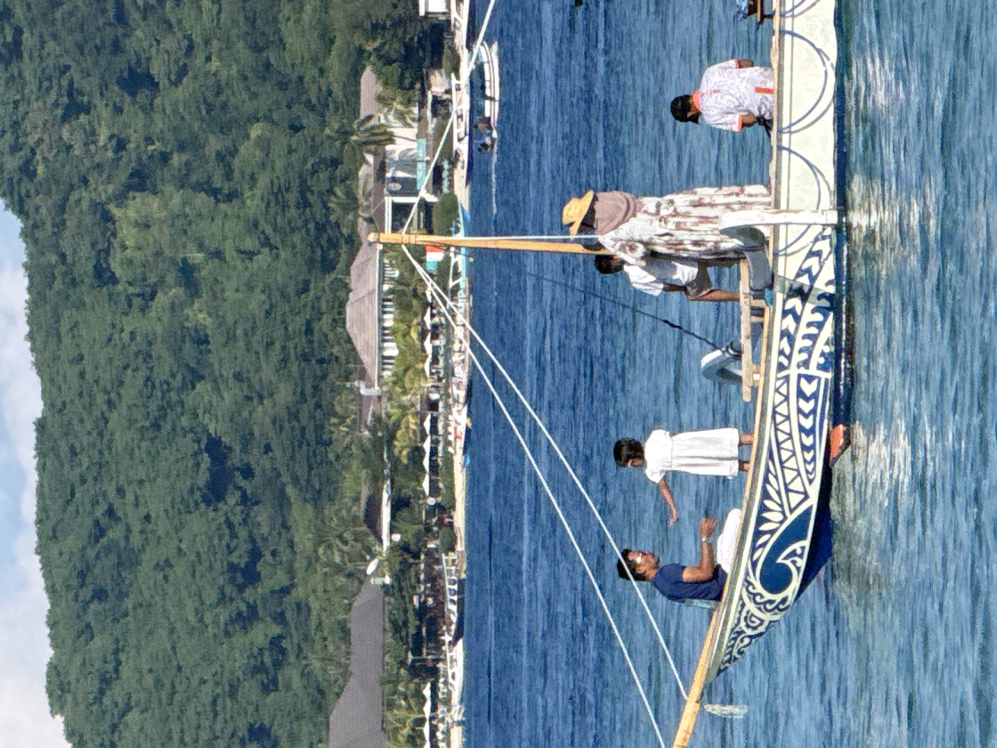 Traditional outrigger canoe navigates Indonesian coastal waters with crew