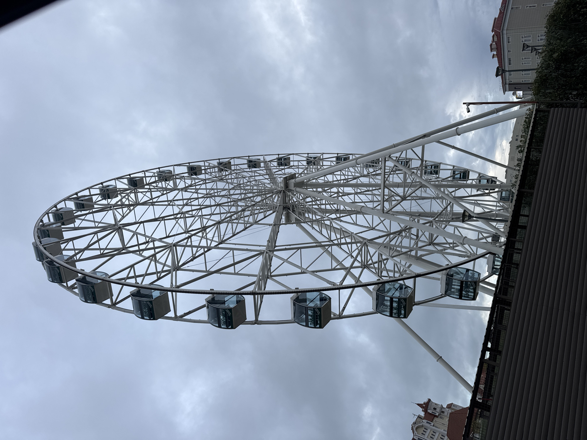 Tourist captures Sirius resort landmarks: Ferris wheel, hotel, mountains