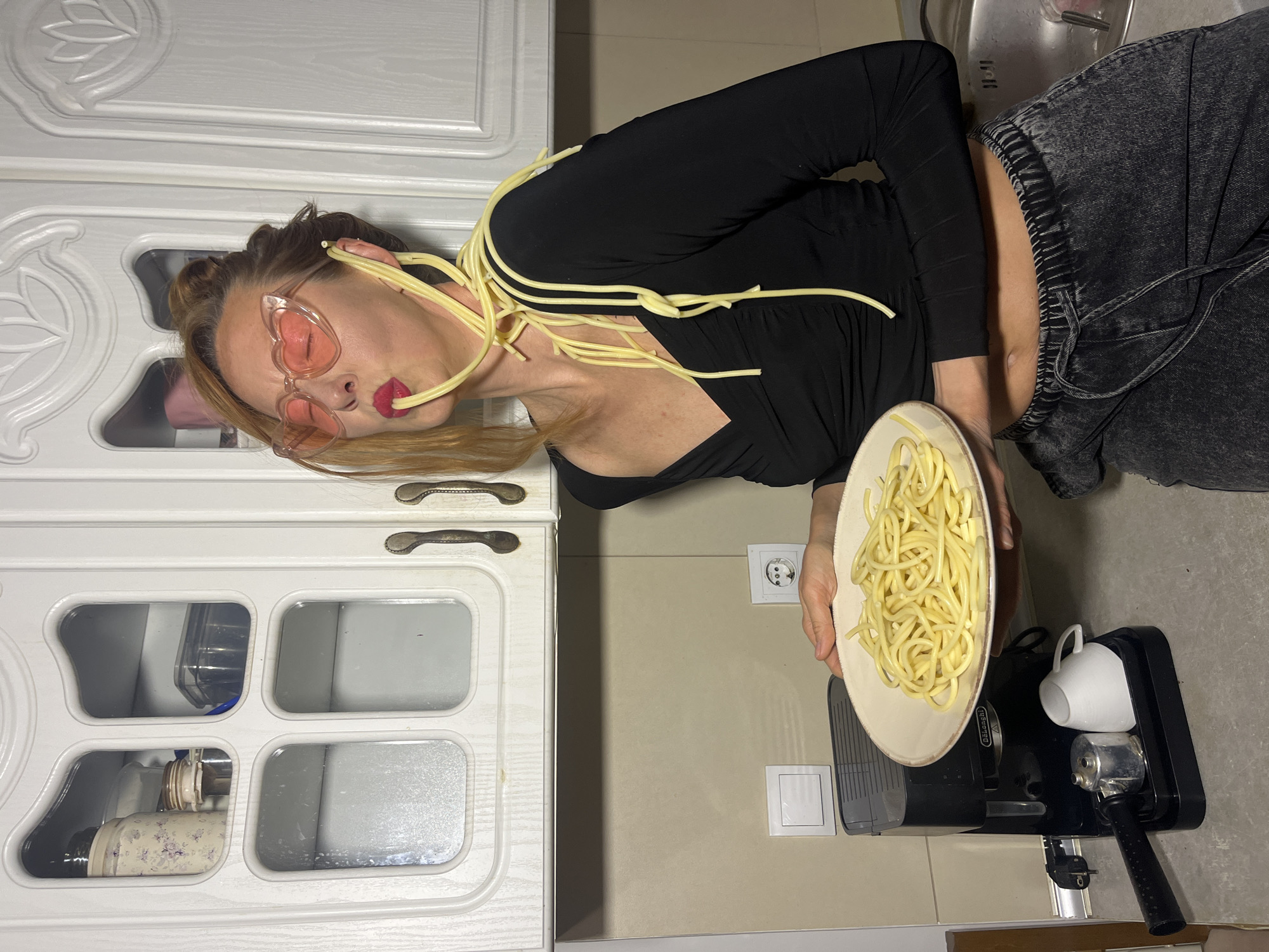 Woman photographs dessert spread in Budva kitchen