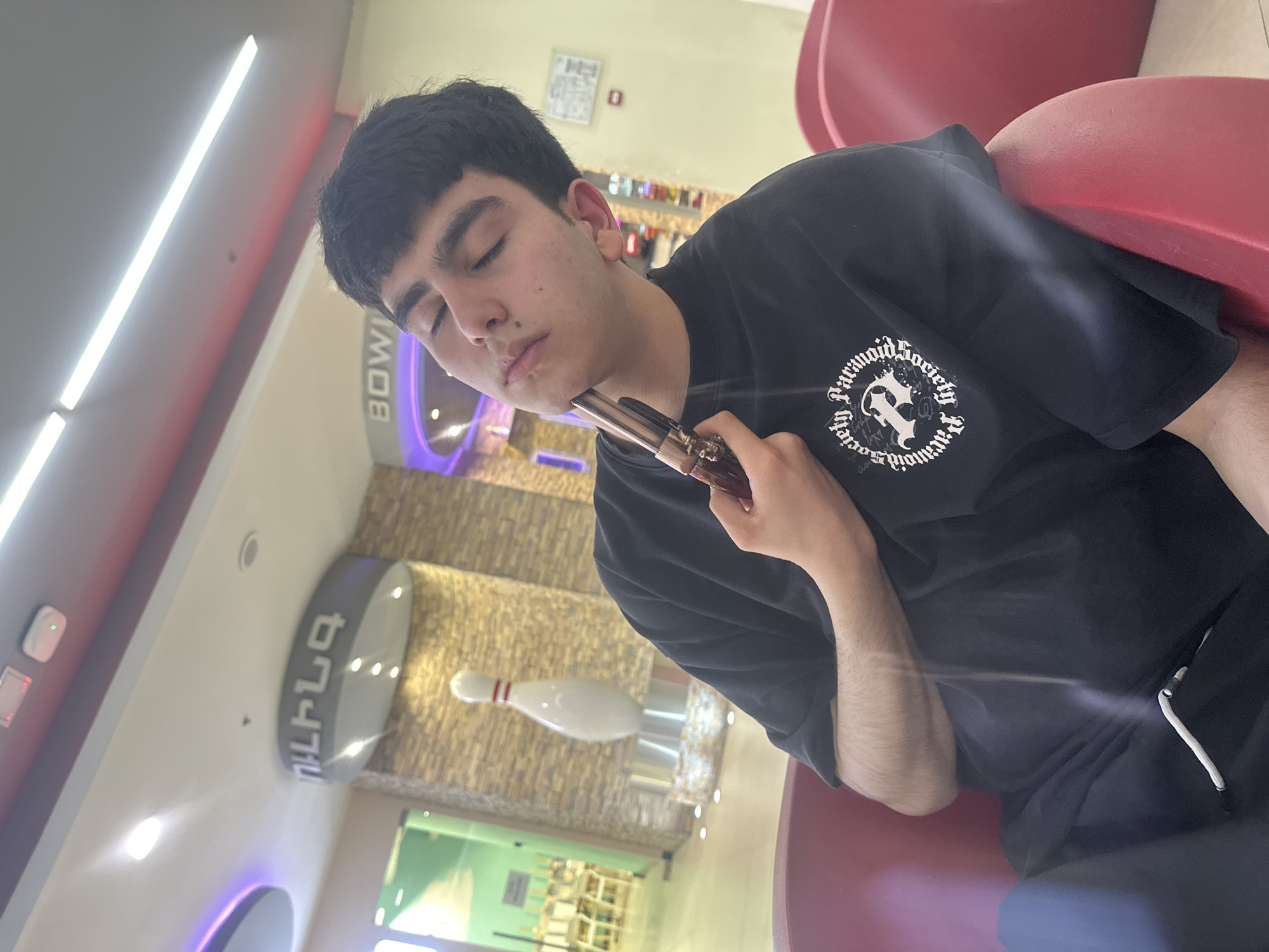 Young men photographed socializing at bowling alley, parking lot