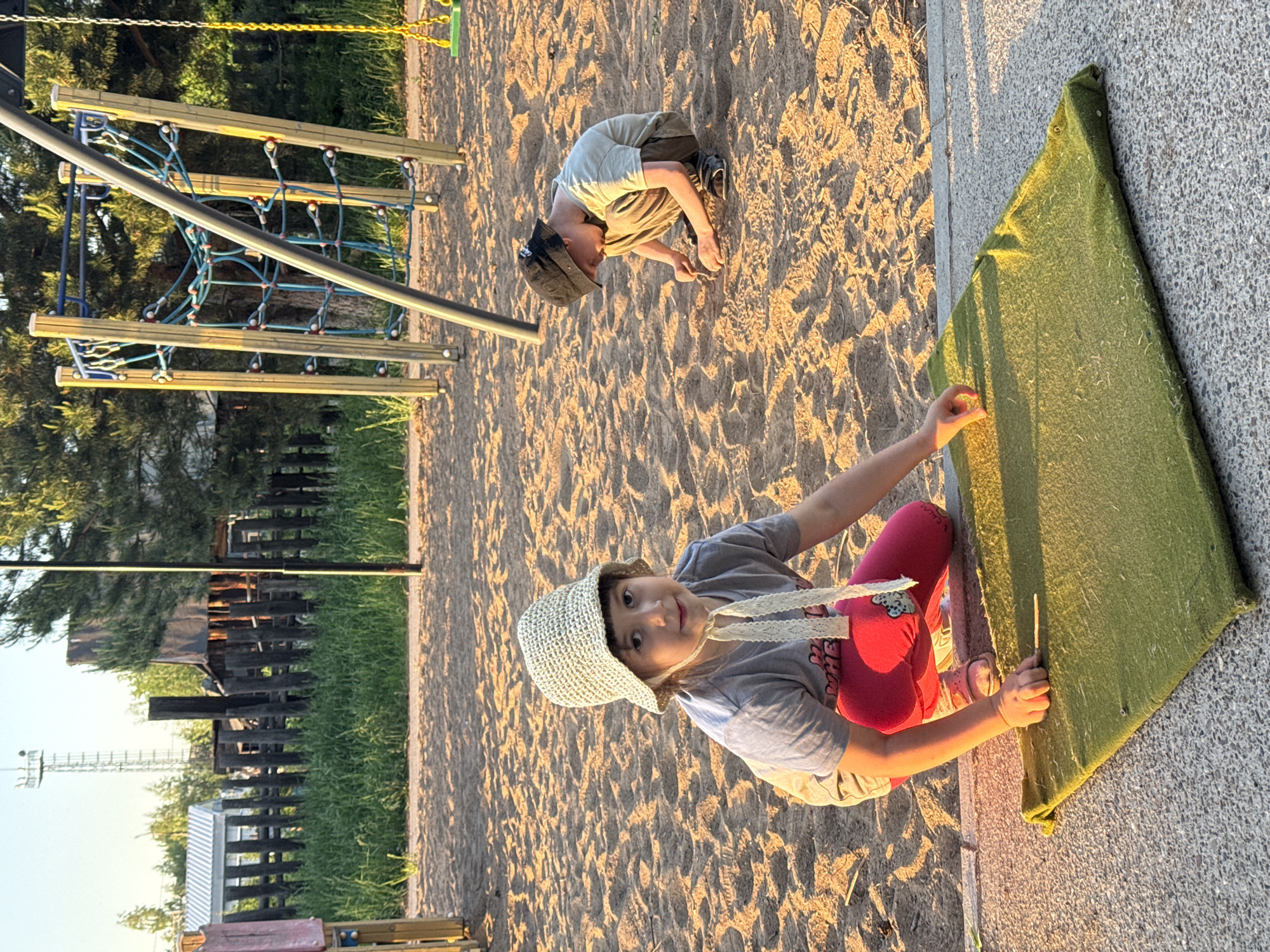 Family enjoys evening playground time with dog in Chaikovsky