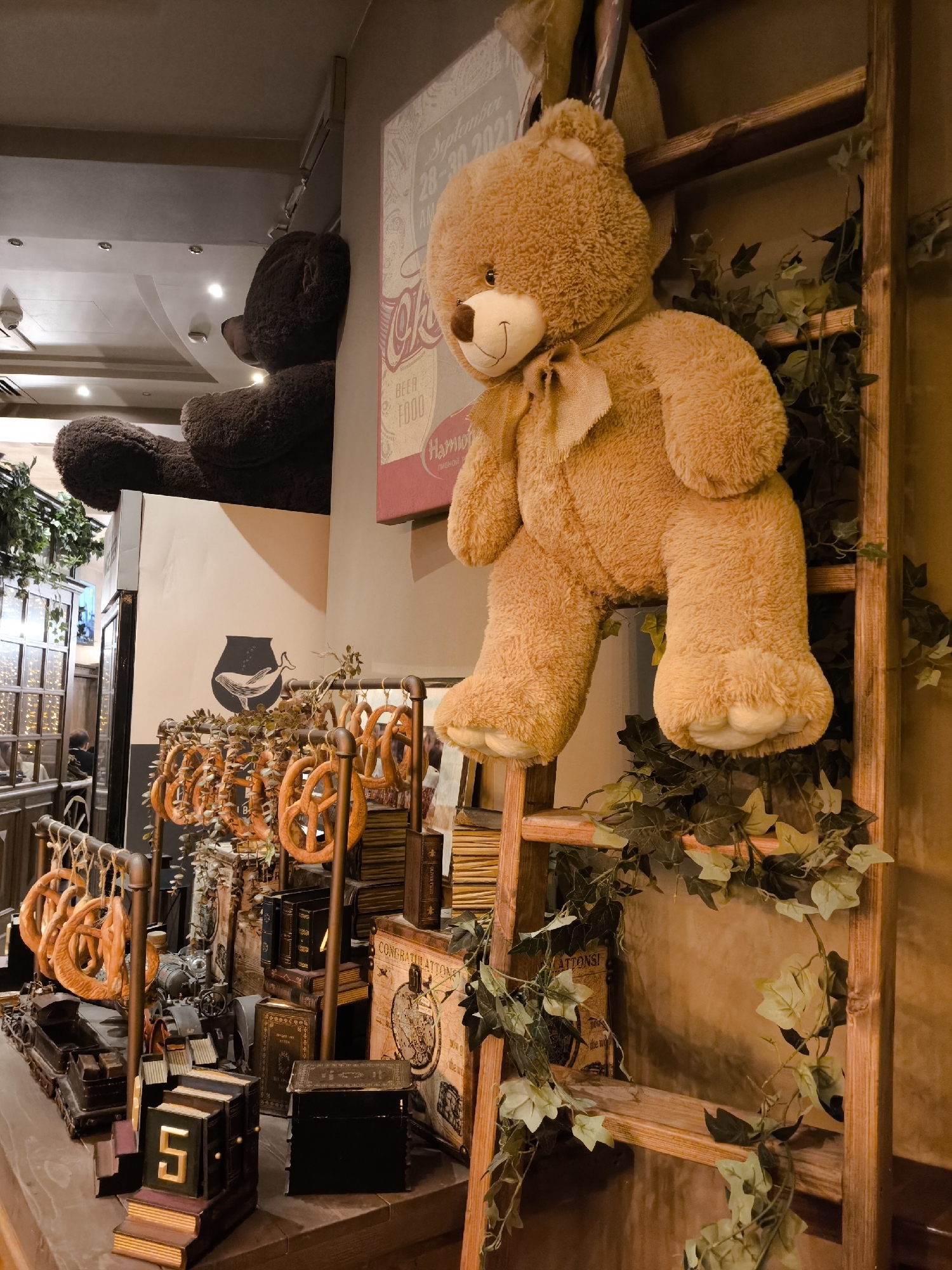 Cozy interior details: vintage trains, a bear display, and backlit glass