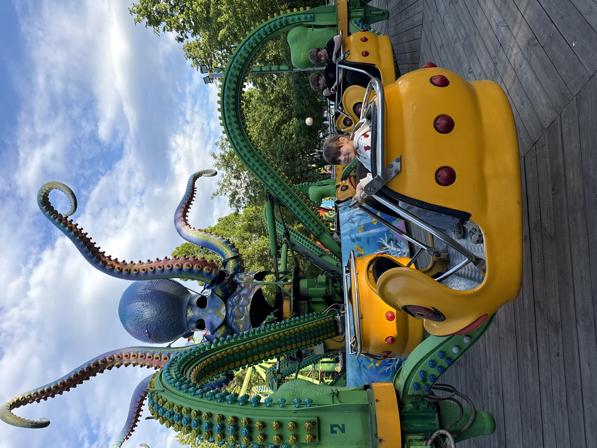 Visitors enjoy octopus ride at Заволжье amusement park