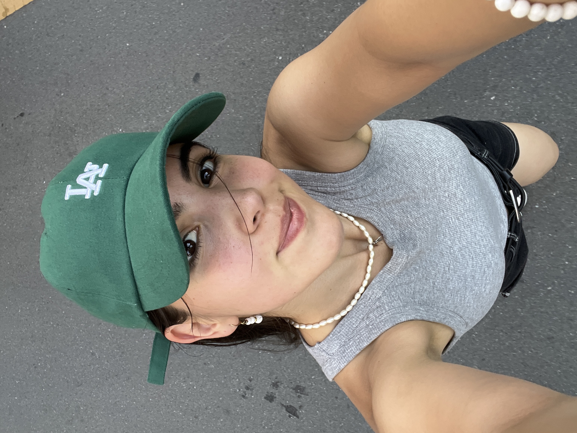 Selfie series on a Daegu street, green LA cap and pearl jewelry