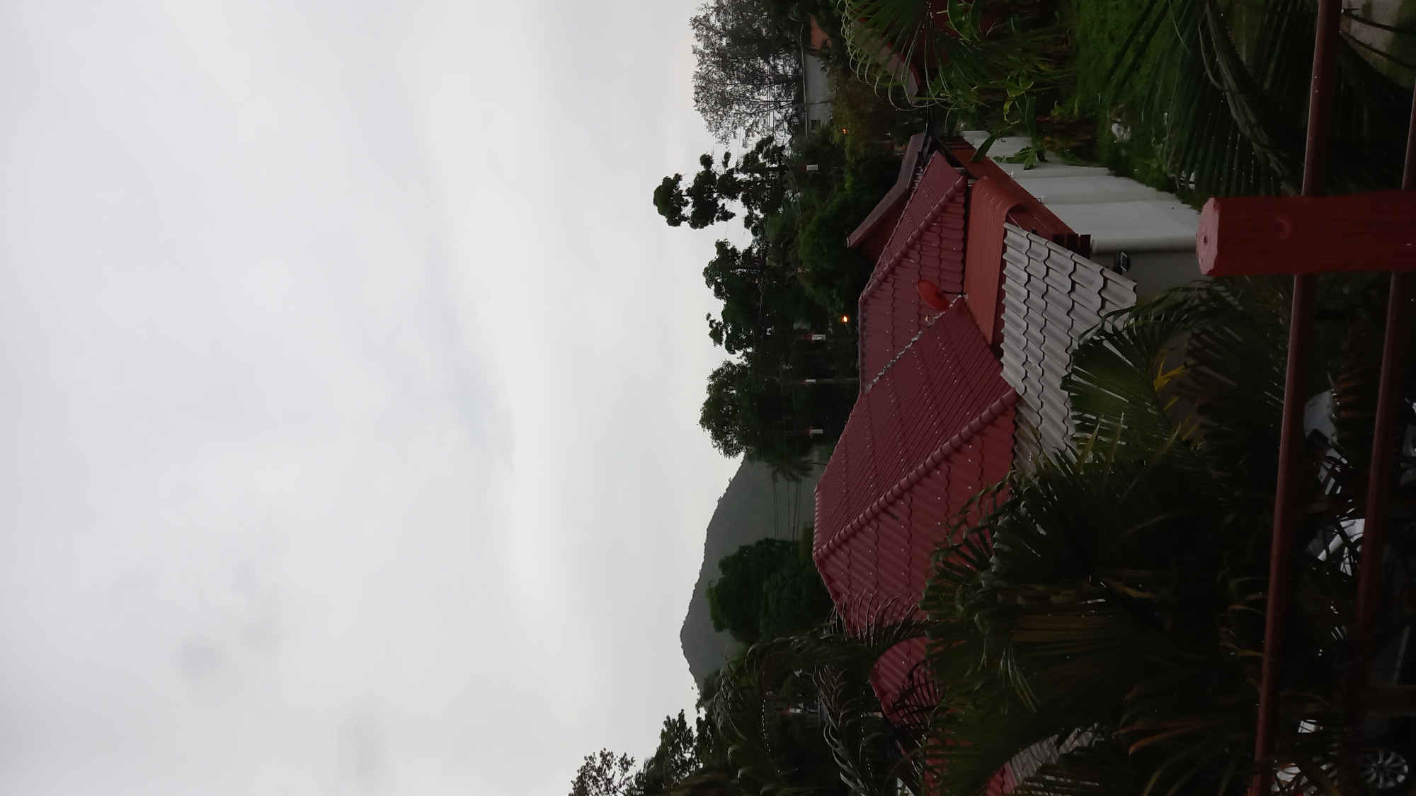 Heavy rain and mist roll over Ko Pha-ngan from a balcony view