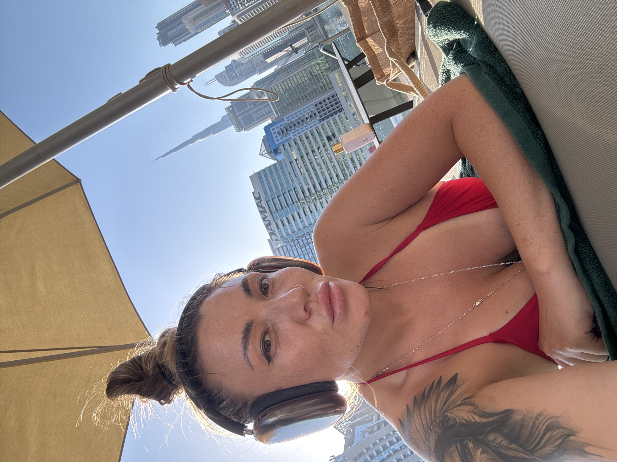 Woman relaxes at Dubai infinity pool overlooking Burj Khalifa
