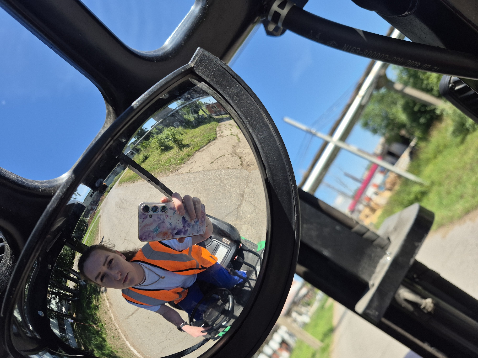 Mirror selfies in orange vests at a Chaikovsky work site