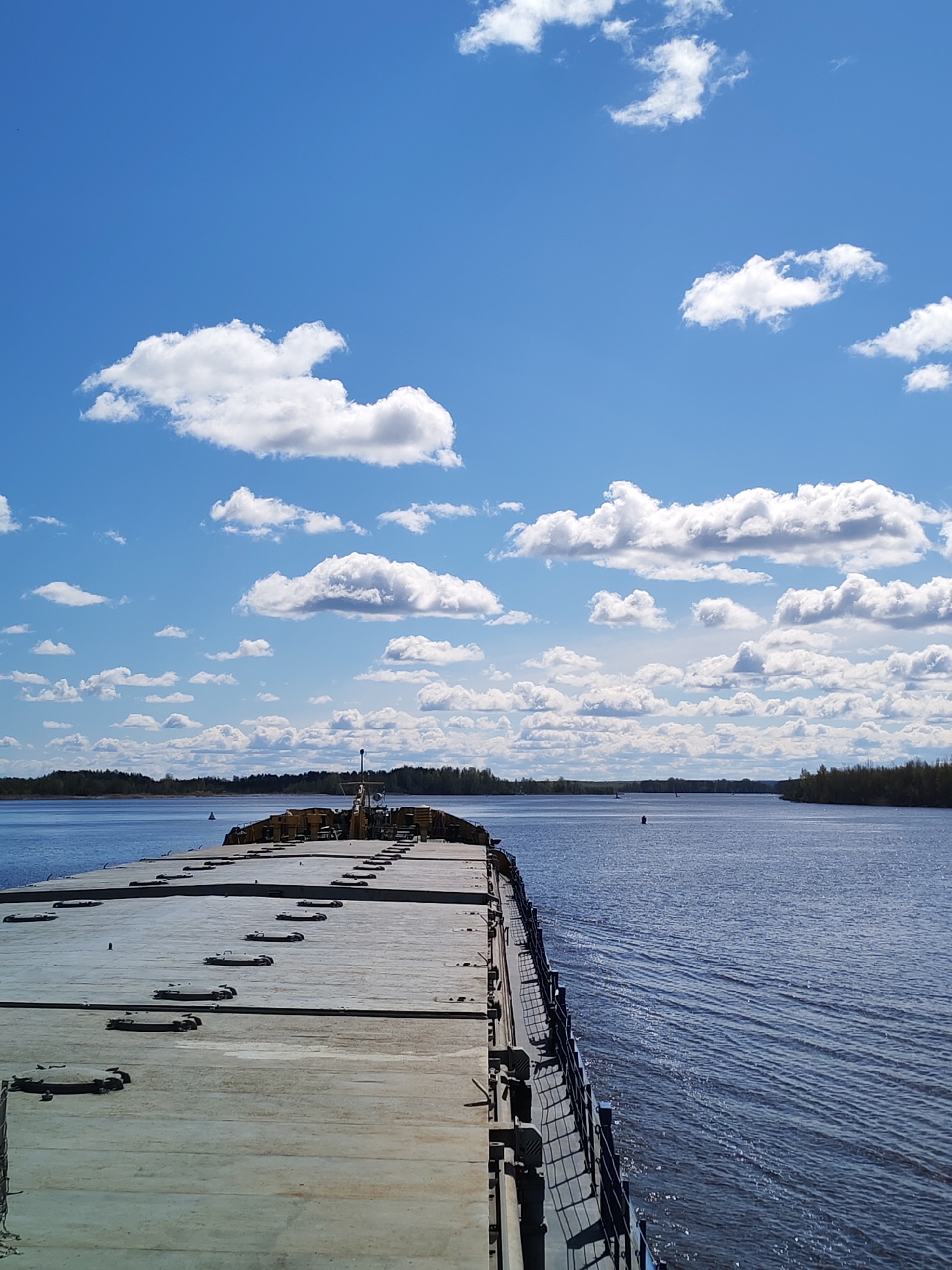 Barge spotted on calm river near Kargulino, Russia
