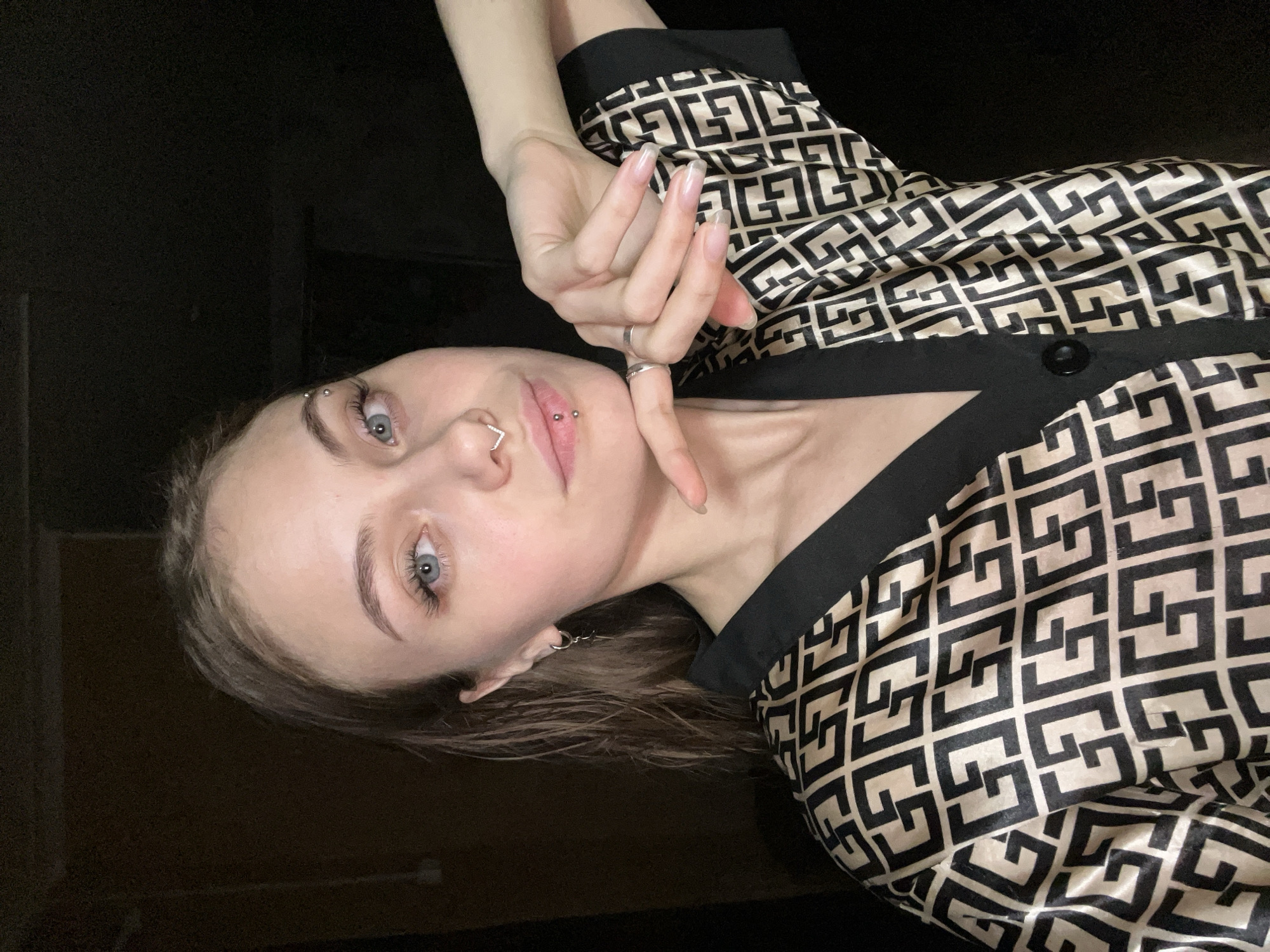Woman with facial piercings photographed indoors in Foki, Russia