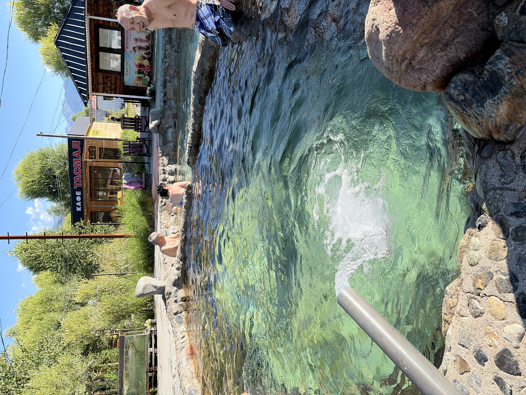Sunny day at a turquoise outdoor hot spring resort