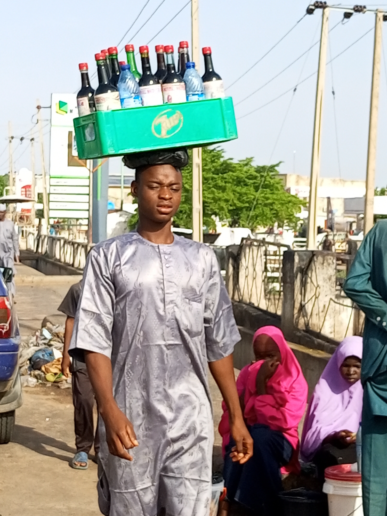 Morning street life in a busy African urban neighborhood