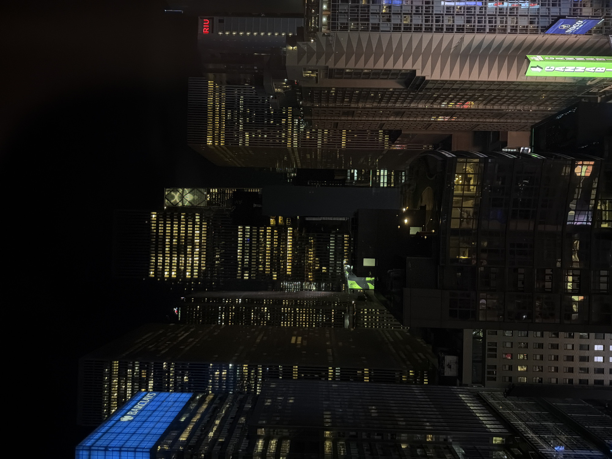 Nighttime aerial view captures illuminated NYC high-rises