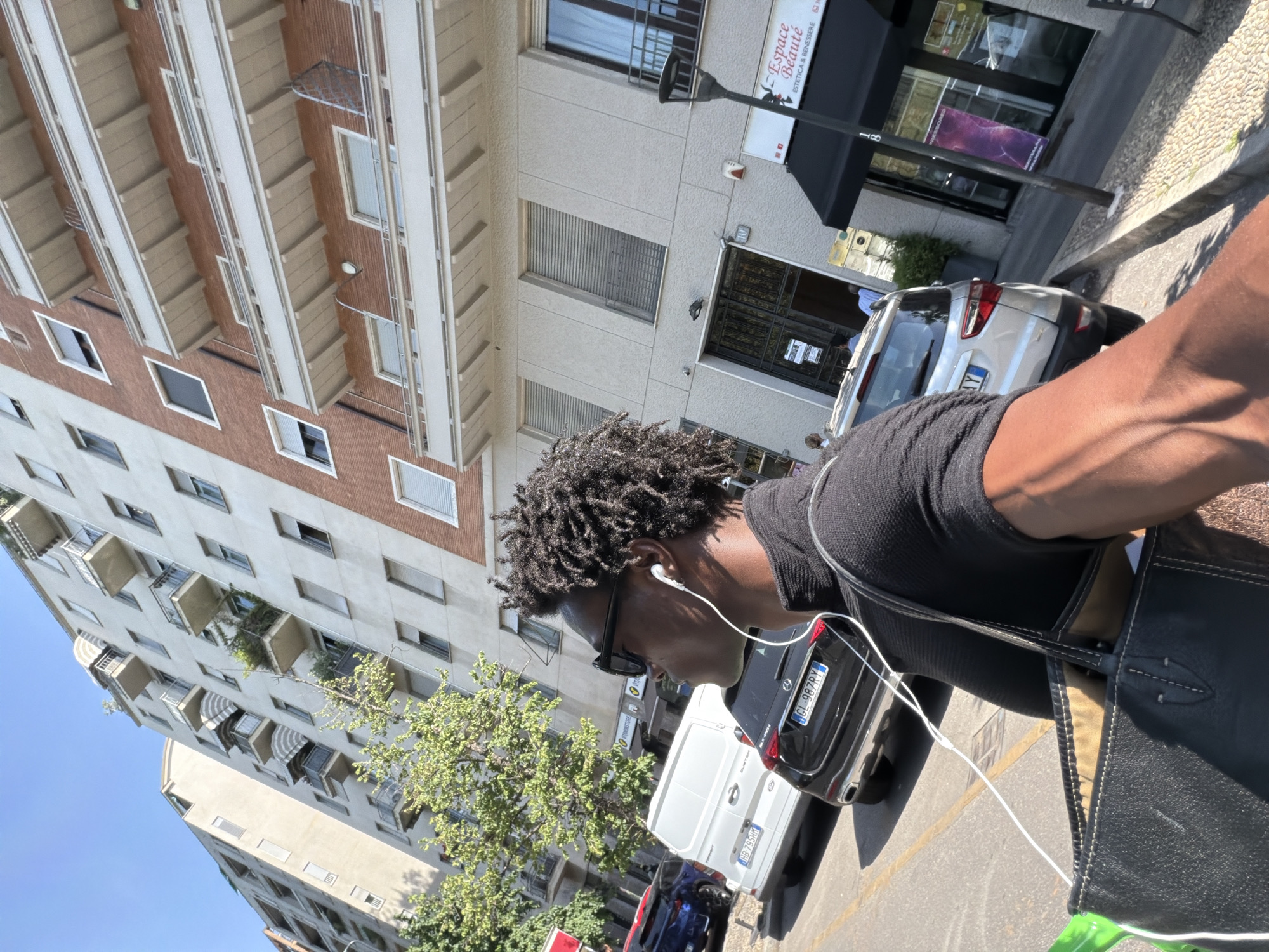 On foot and on scooter through the same Milan street