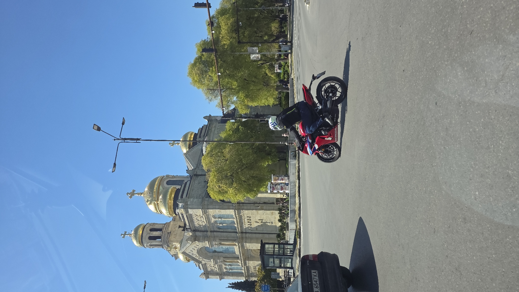 Everyday street life continues around Varna cathedral