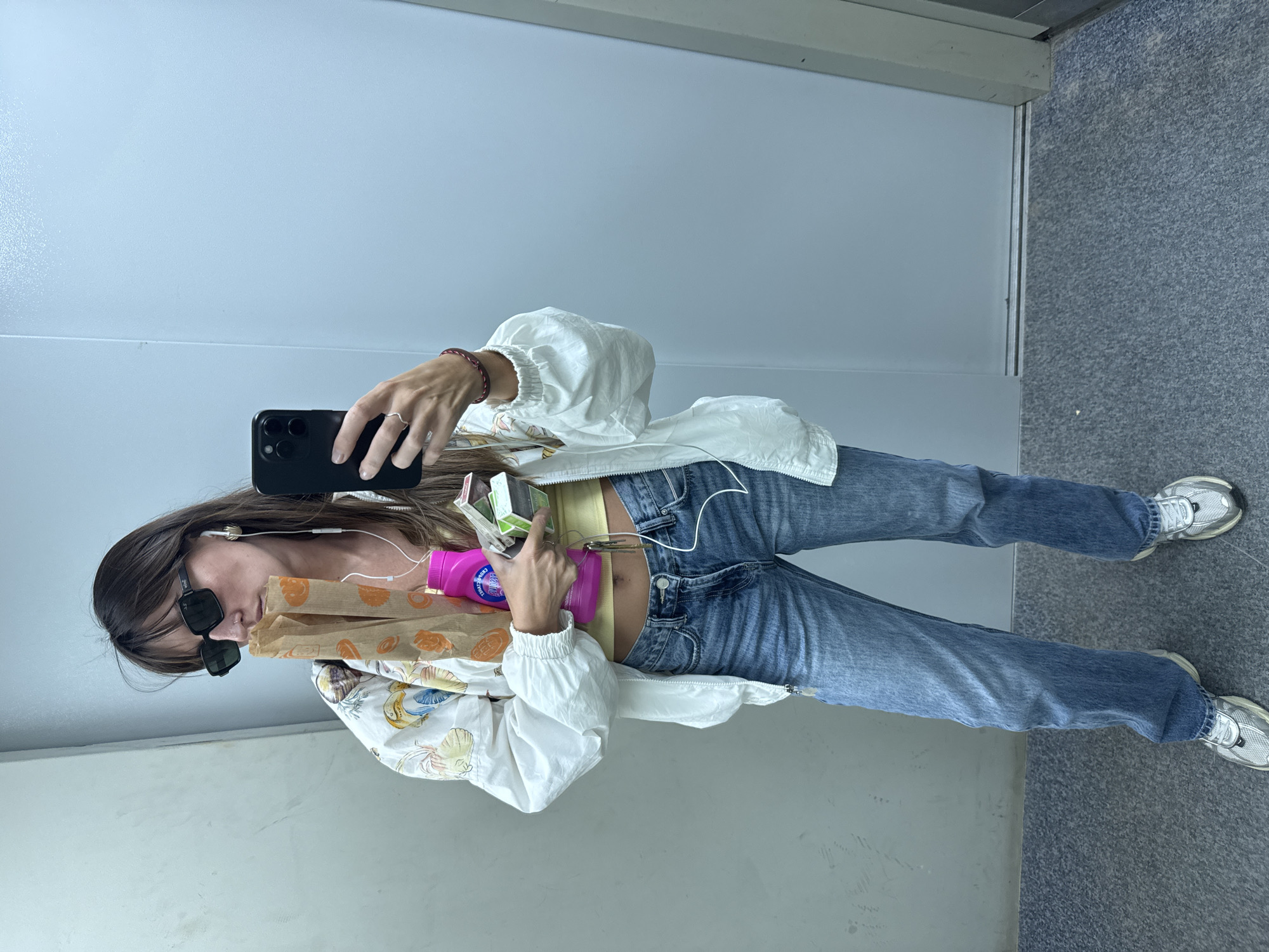 Mirror selfie in a Moscow elevator, bold printed jacket.