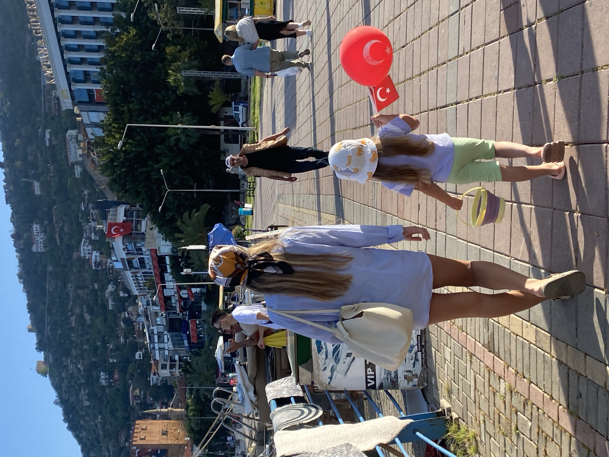 Tourist documents pirate ships and flowers during Alanya harbor walk