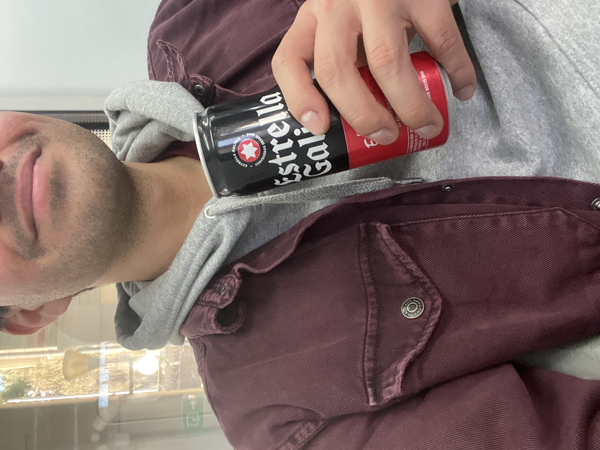 Person enjoys Estrella Galicia beer in Caldes d'Estrac