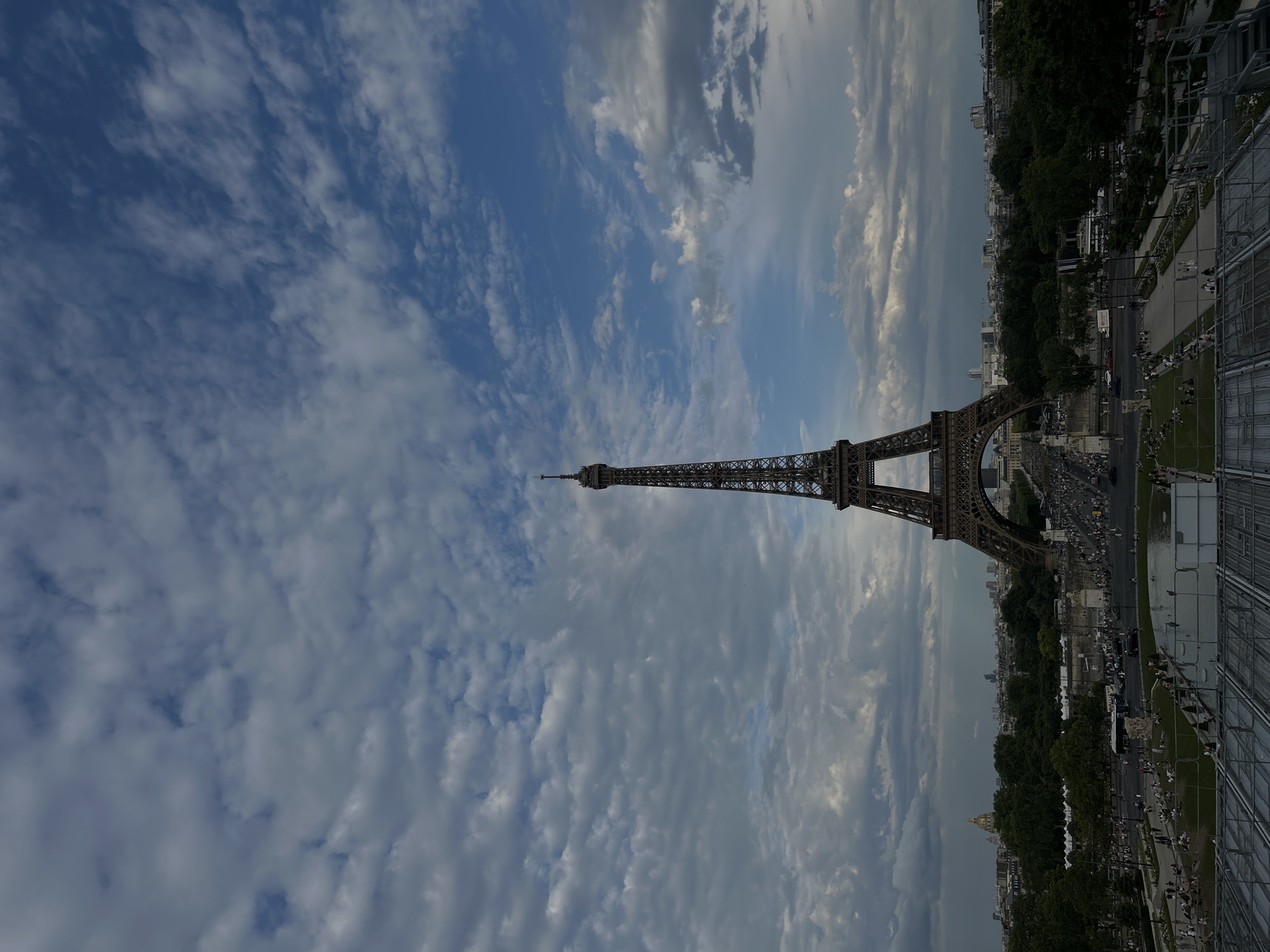 Eiffel Tower park scene on a cloudy summer afternoon