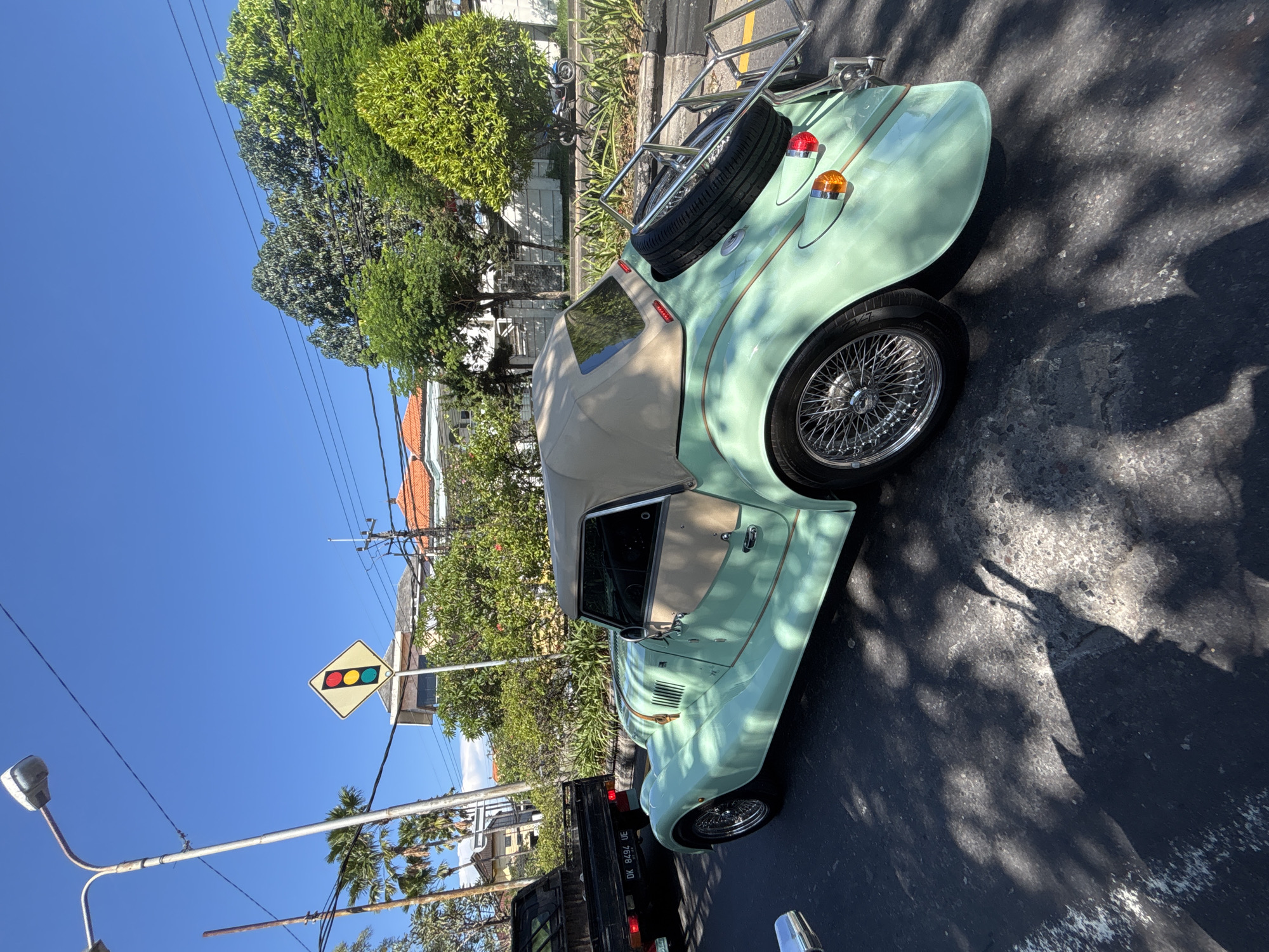 Vintage green convertible spotted parked in Denpasar street
