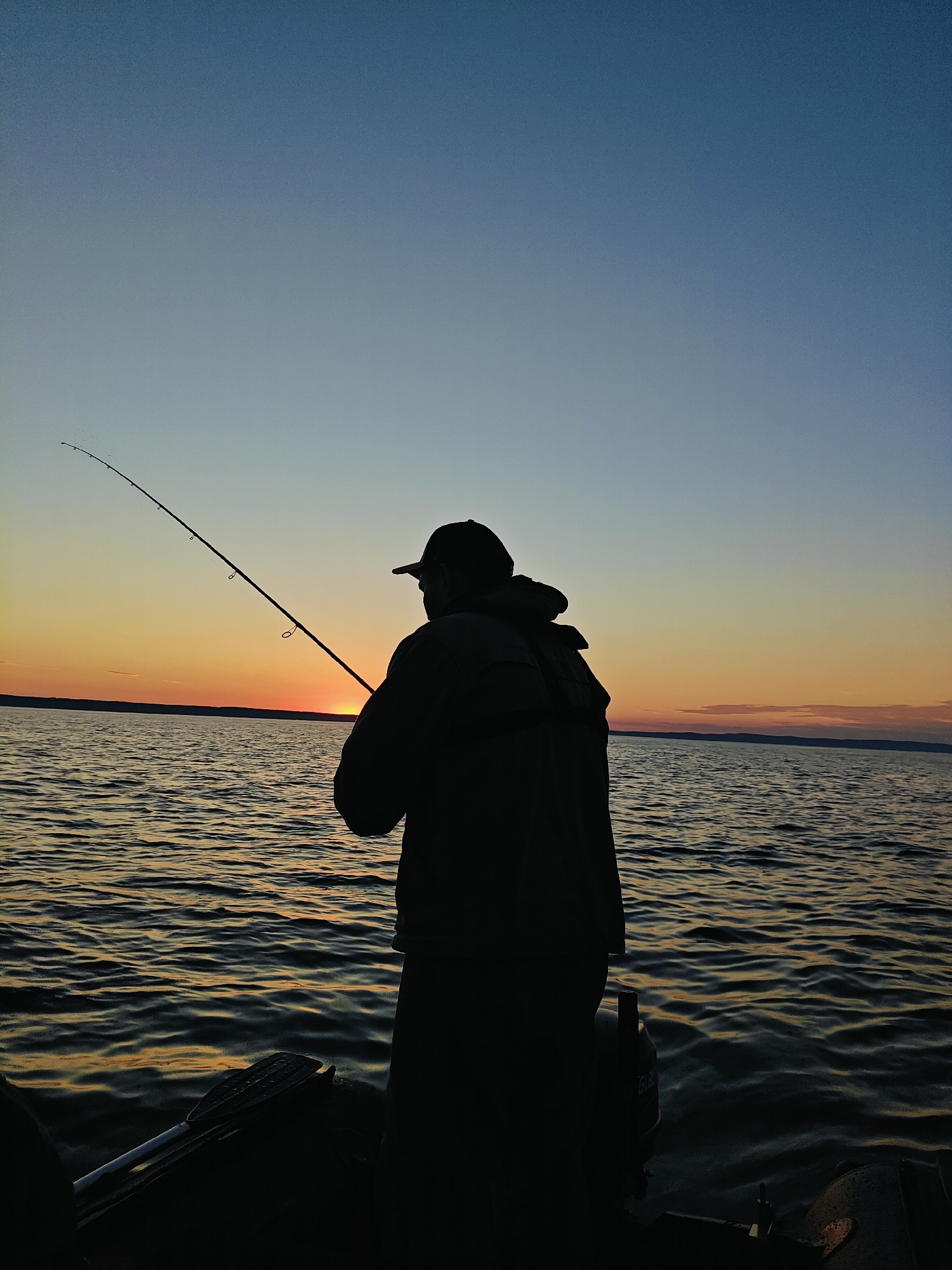 Boat fishing on the Kama River at golden hour