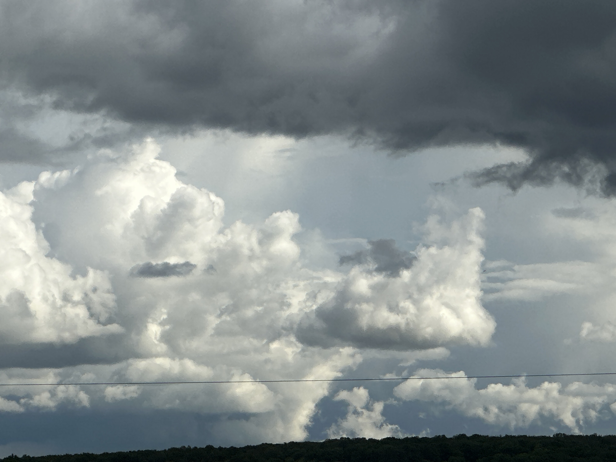 Storm clouds gather over urban landscape during afternoon
