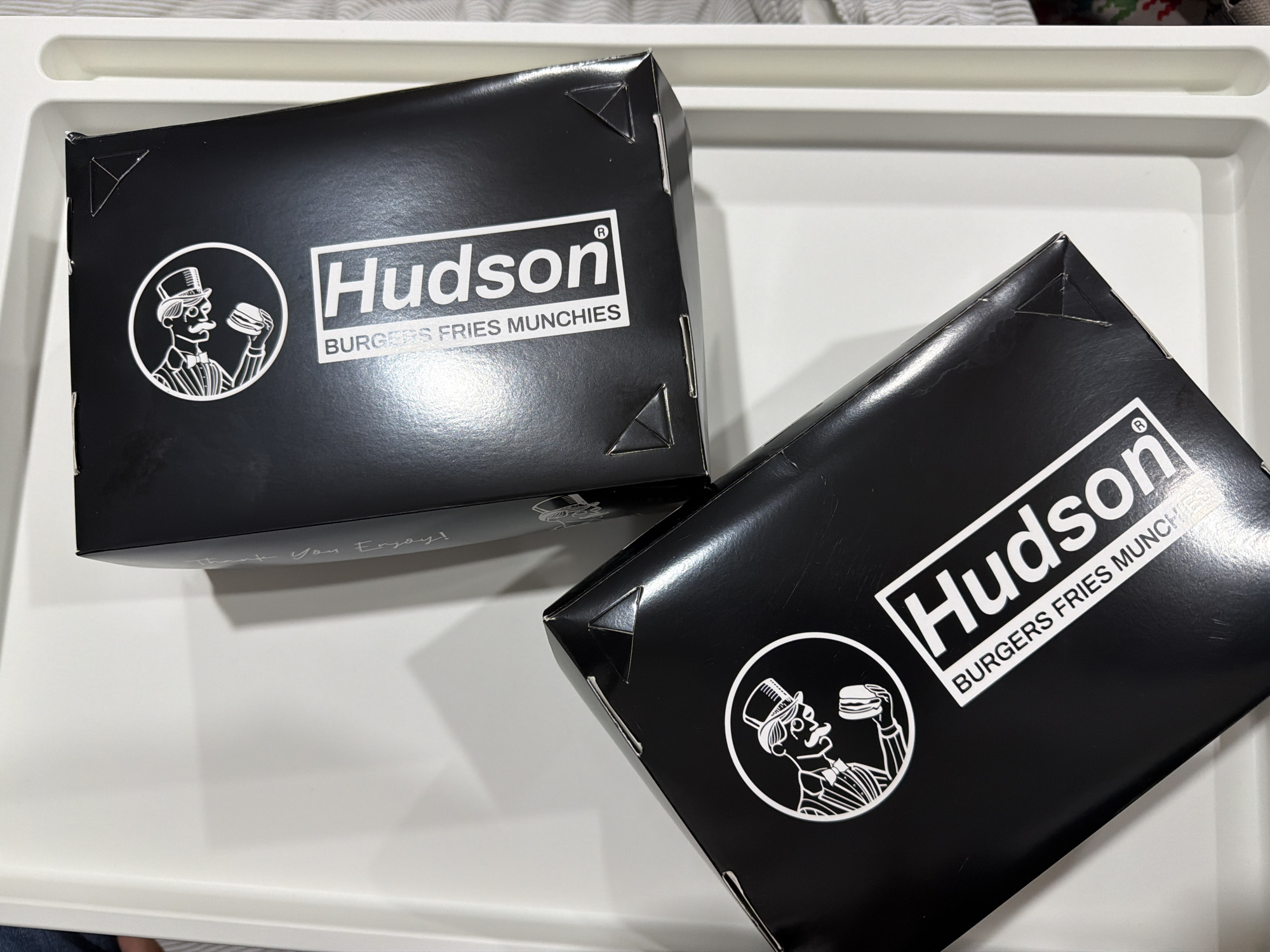 Hudson Burgers food boxes spotted on white tray