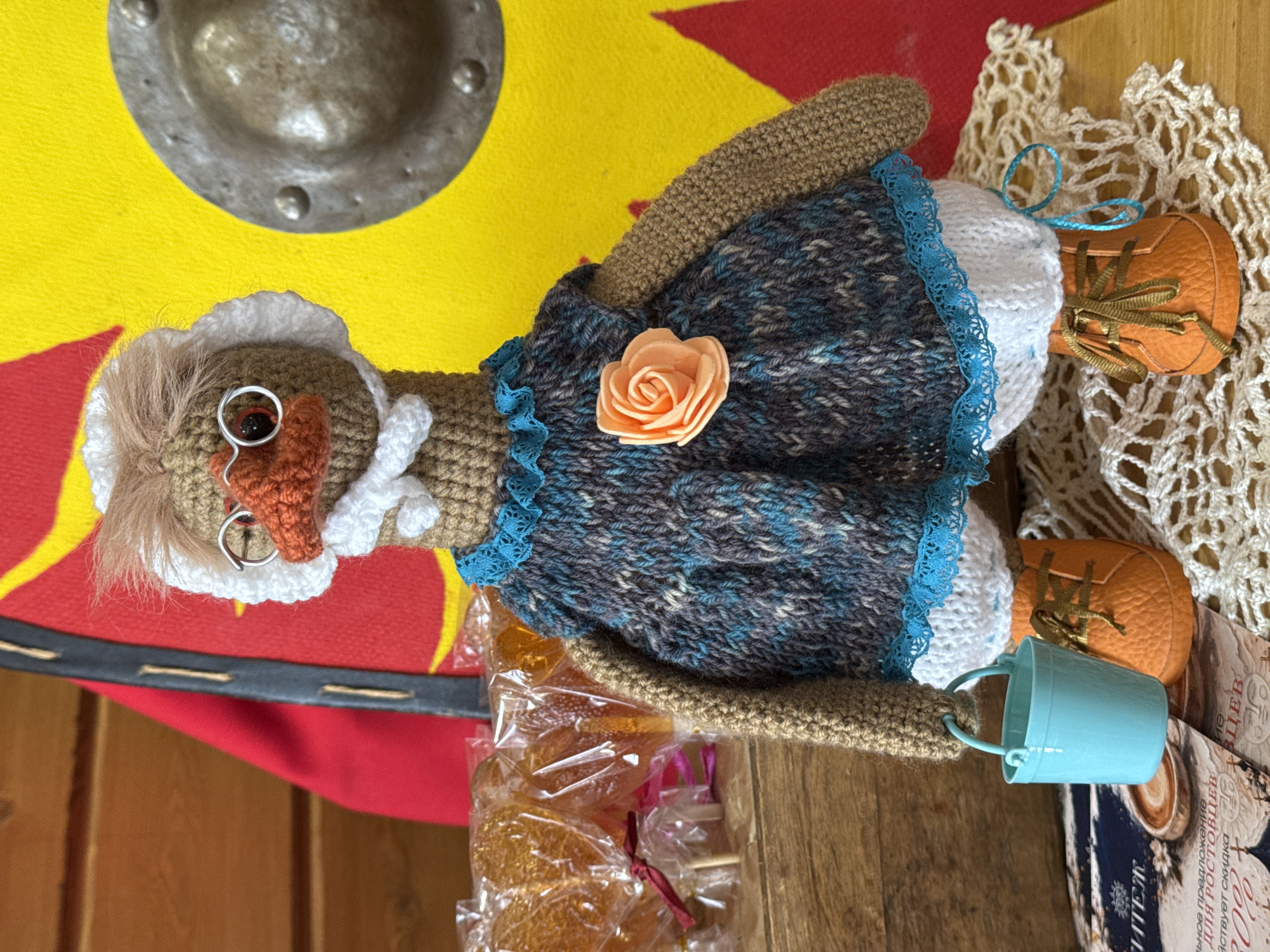 Handcrafted dolls and wooden toys displayed on wooden surfaces