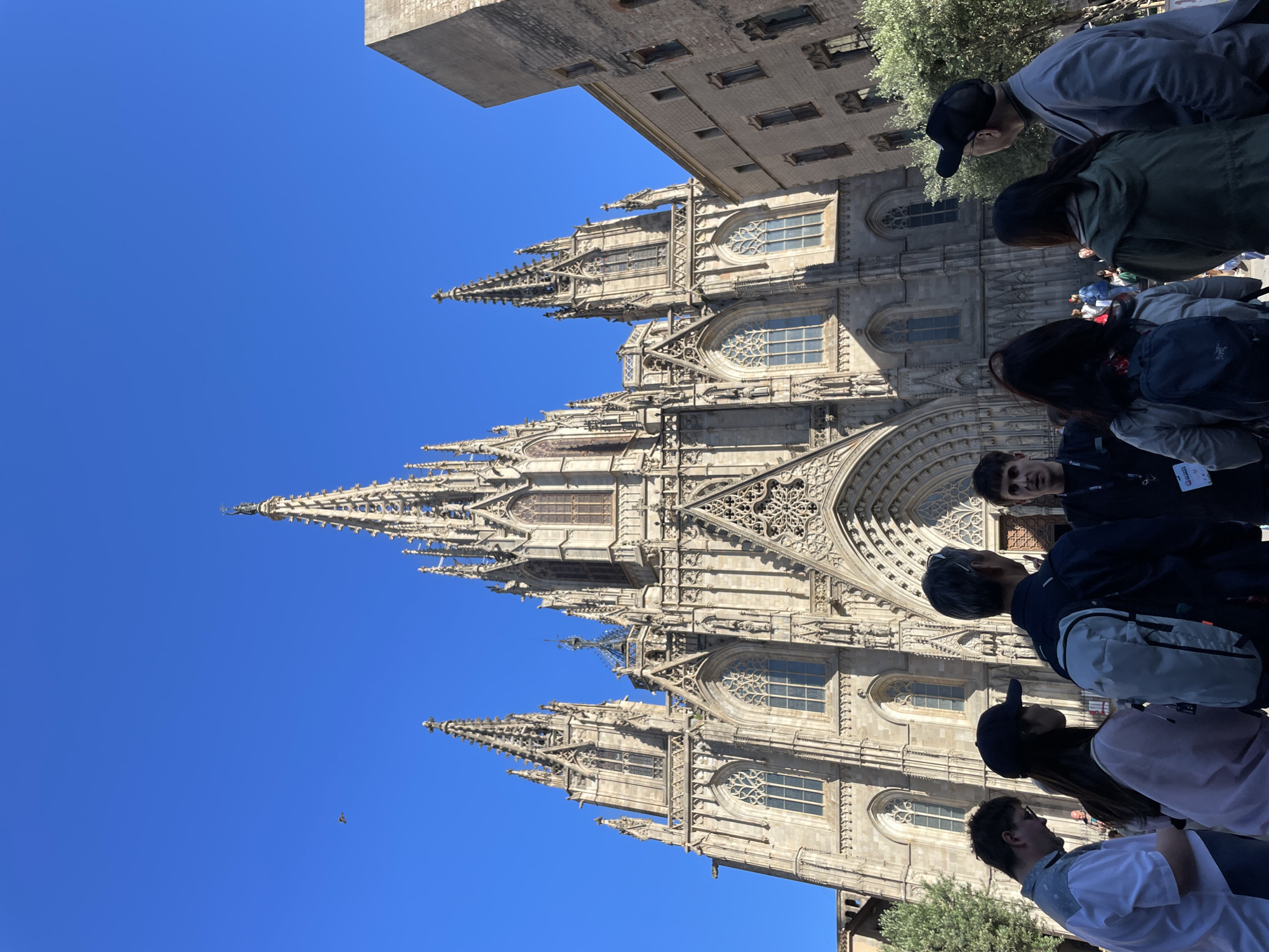 Female duo busks outside Barcelona Cathedral drawing afternoon crowds