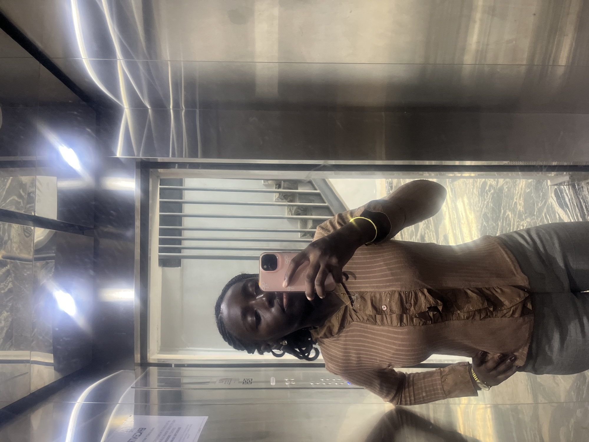 Woman Takes Selfies in Elevator with Illuminated Portraits in Karum