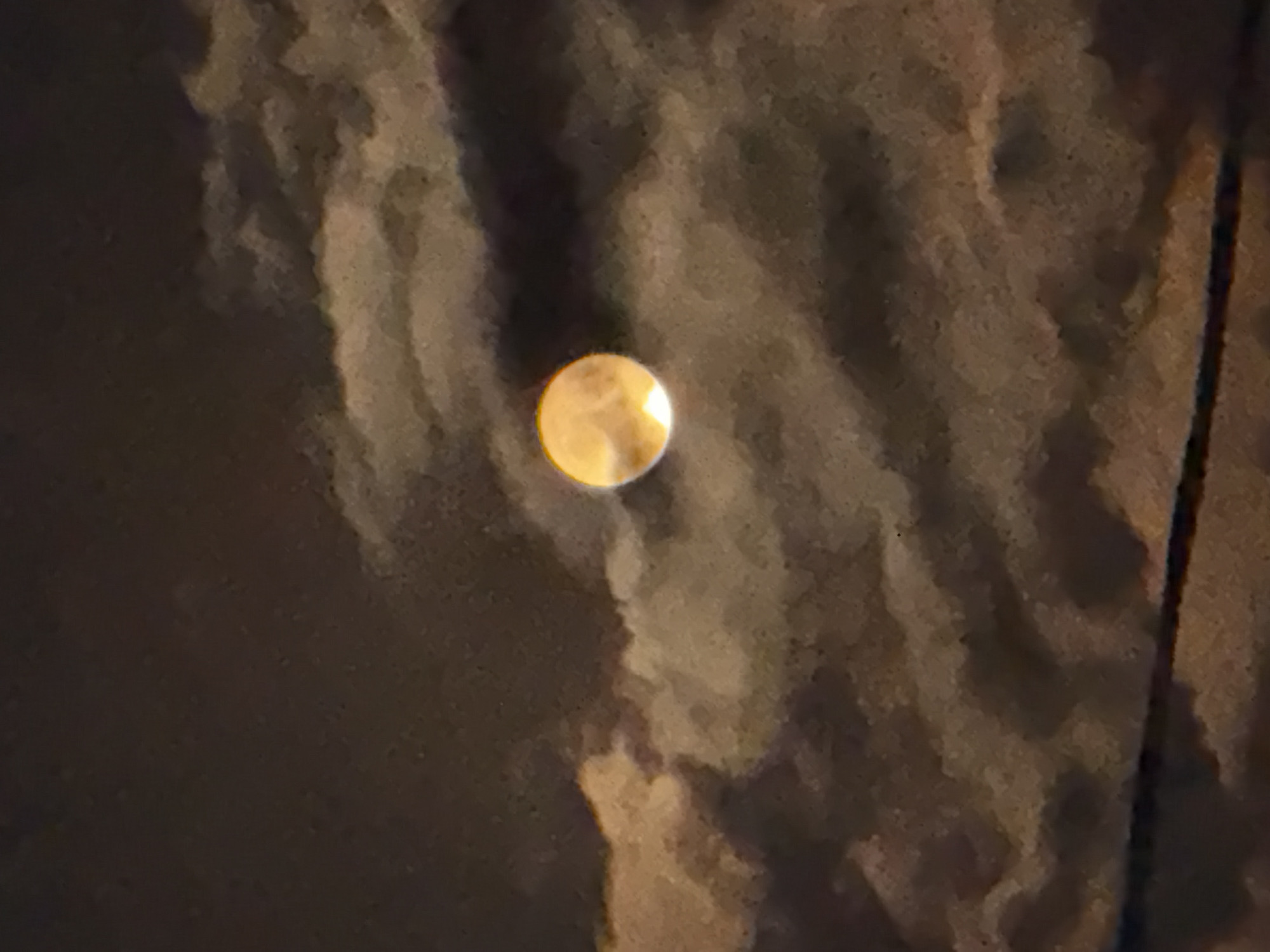 Full moon breaking through clouds over Sokhumi