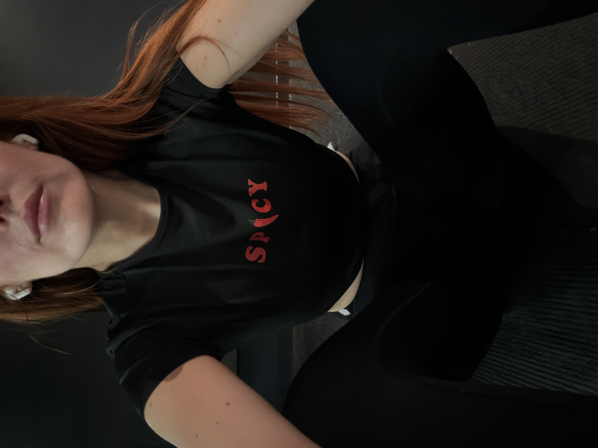 Person in SPICY shirt rests on surface in Paris