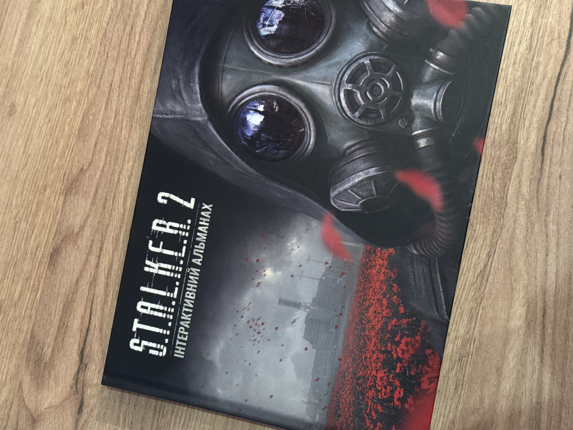 Person unboxes S.T.A.L.K.E.R. 2 trading cards in Kyiv