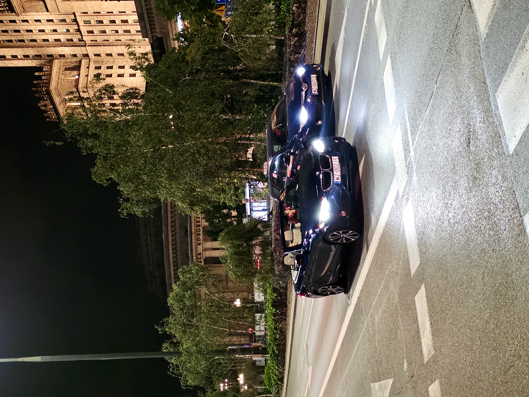 Night drive through Warsaw's lit-up city center