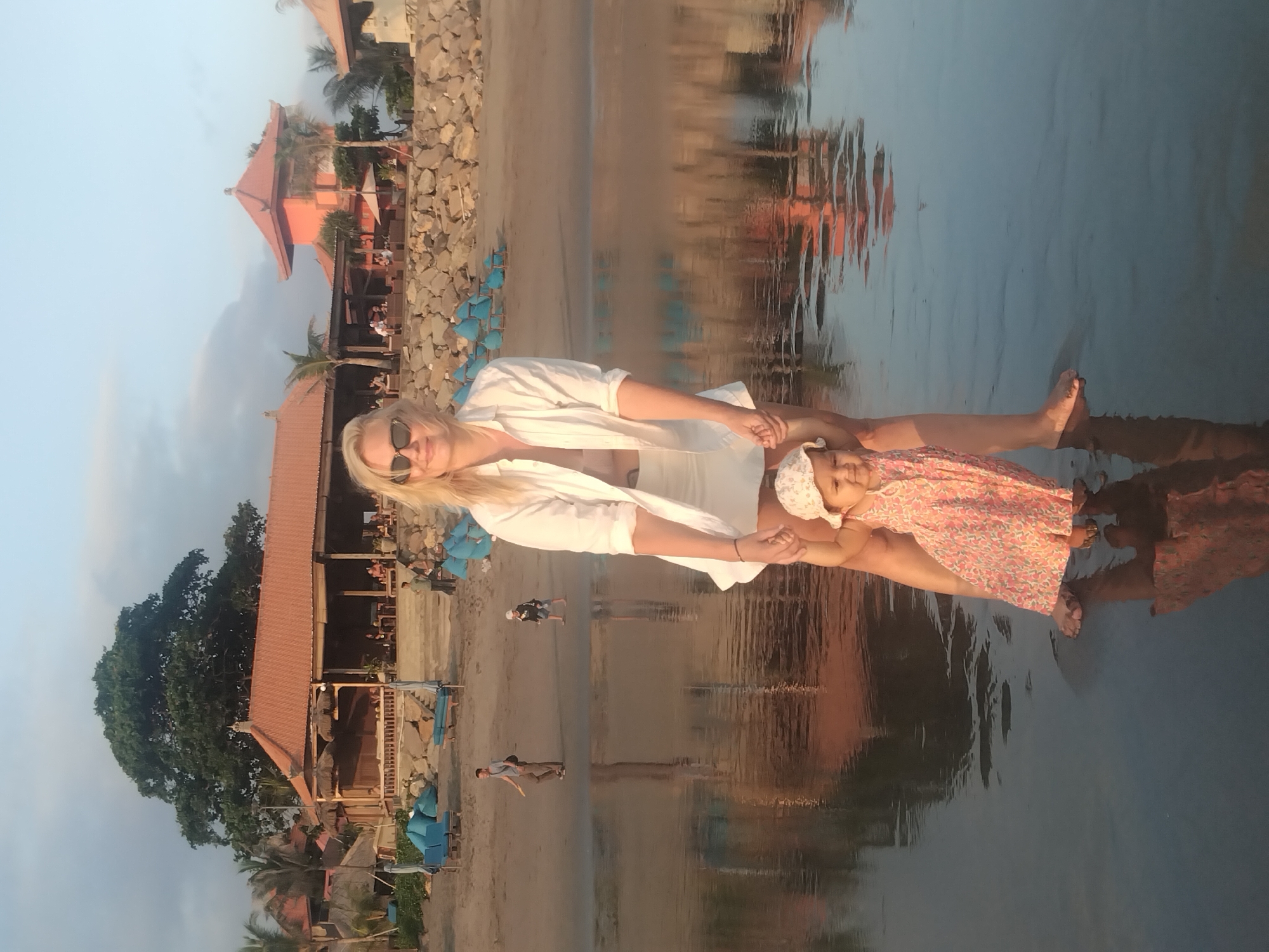 Woman and children spotted at beach during evening hours
