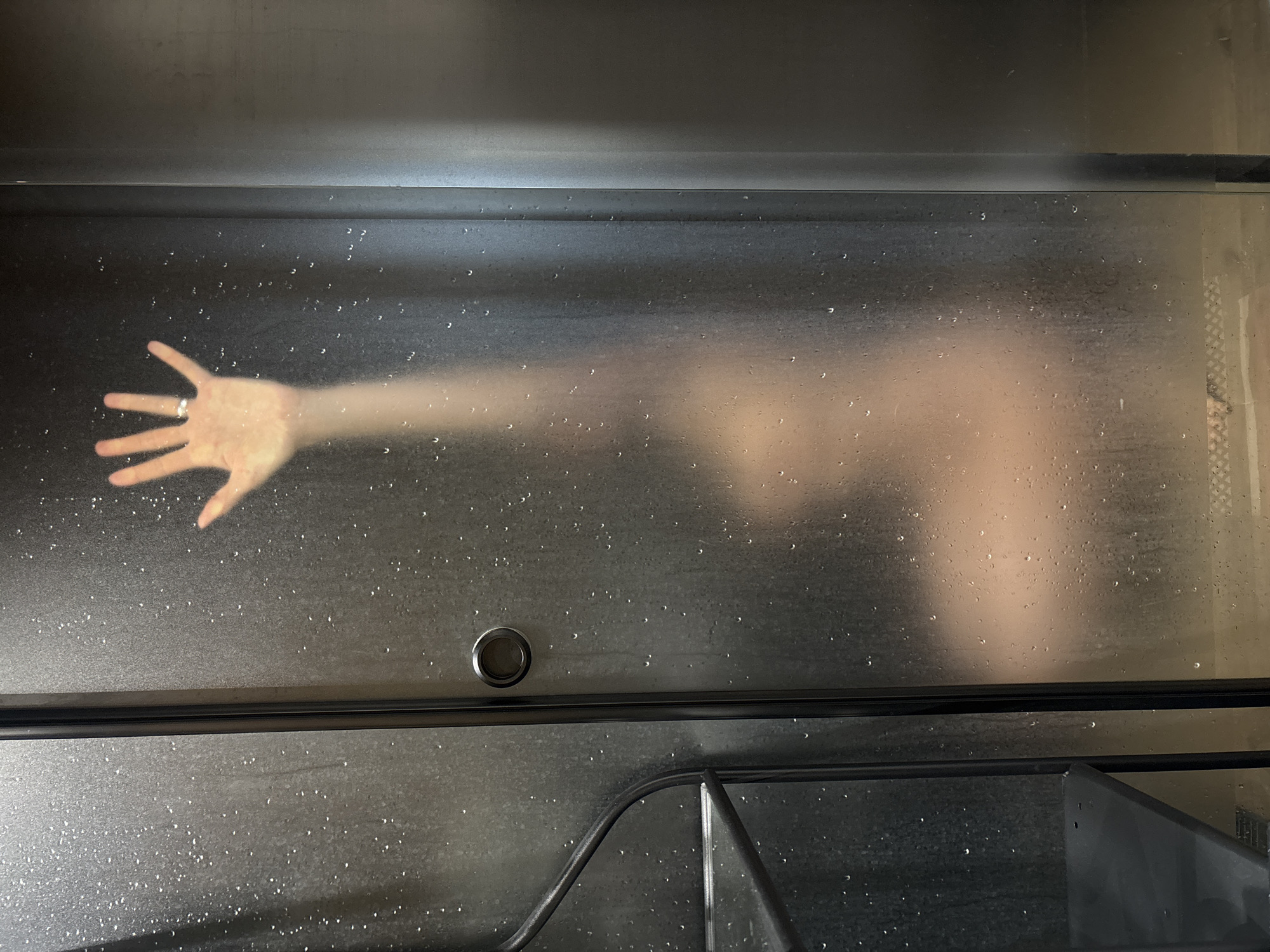Morning shower routine captured behind steamed glass in Chaikovsky